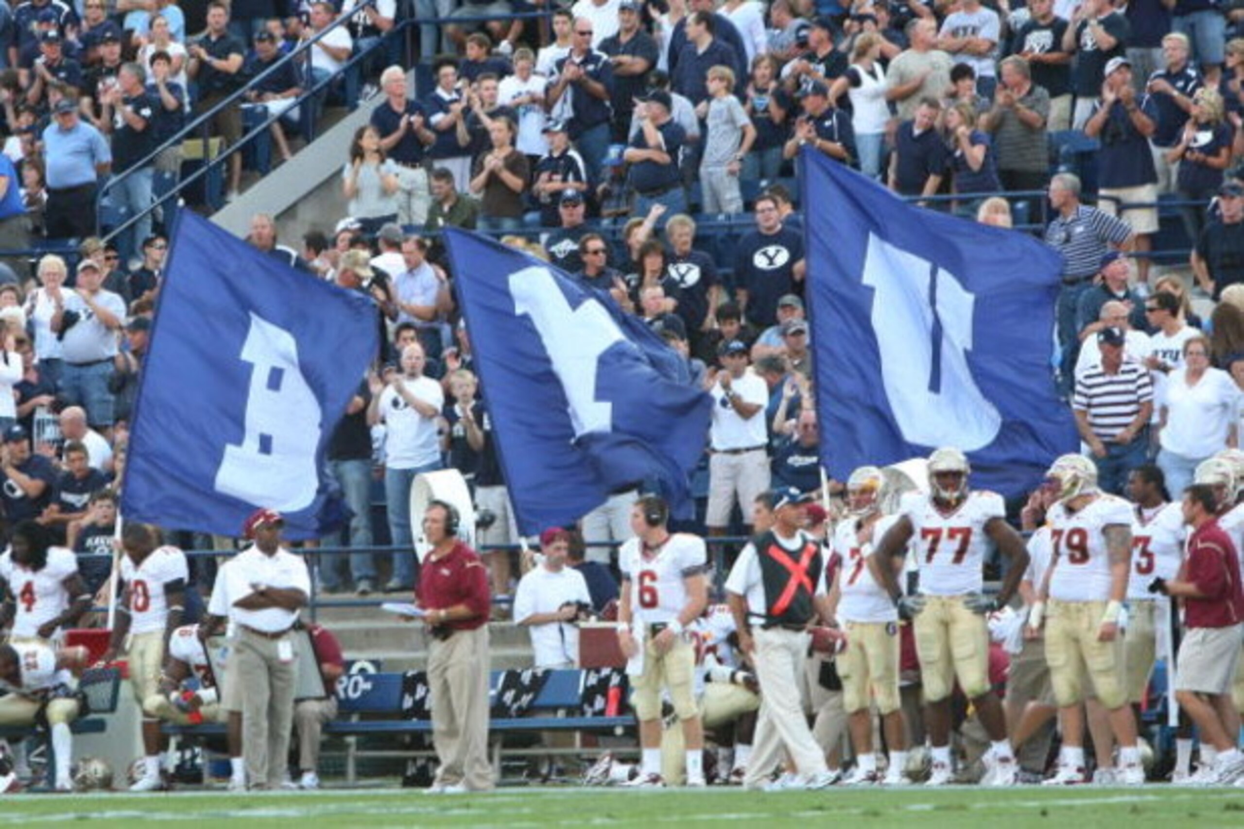 PROVO, UT. - SEPTEMBER 19: Brigham Young Cougars flag bearers run around the field after a touchdown against the Florida State Seminoles at La Vell Edwards Stadium on September 19, 2009 in Provo, Utah. (Photo by Melissa Majchrzak/Getty Images) PROVO, UT. - SEPTEMBER 19: Brigham Young Cougars flag bearers run around the field after a touchdown against the Florida State Seminoles at La Vell Edwards Stadium on September 19, 2009 in Provo, Utah. (Photo by Melissa Majchrzak/Getty Images)