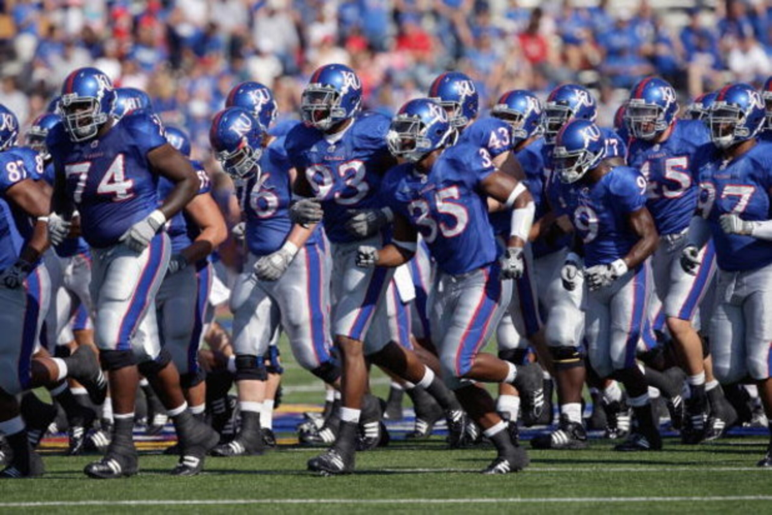 LAWRENCE, KS - SEPTEMBER 19: The Kansas Jayhawks jog onto the field before the game against the Duke Blue Devils on Kivisto Field at Memorial Stadium on September 19, 2009 in Lawrence, Kansas. (Photo by Jamie Squire/Getty Images) LAWRENCE, KS - SEPTEMBER 19: The Kansas Jayhawks jog onto the field before the game against the Duke Blue Devils on Kivisto Field at Memorial Stadium on September 19, 2009 in Lawrence, Kansas. (Photo by Jamie Squire/Getty Images)