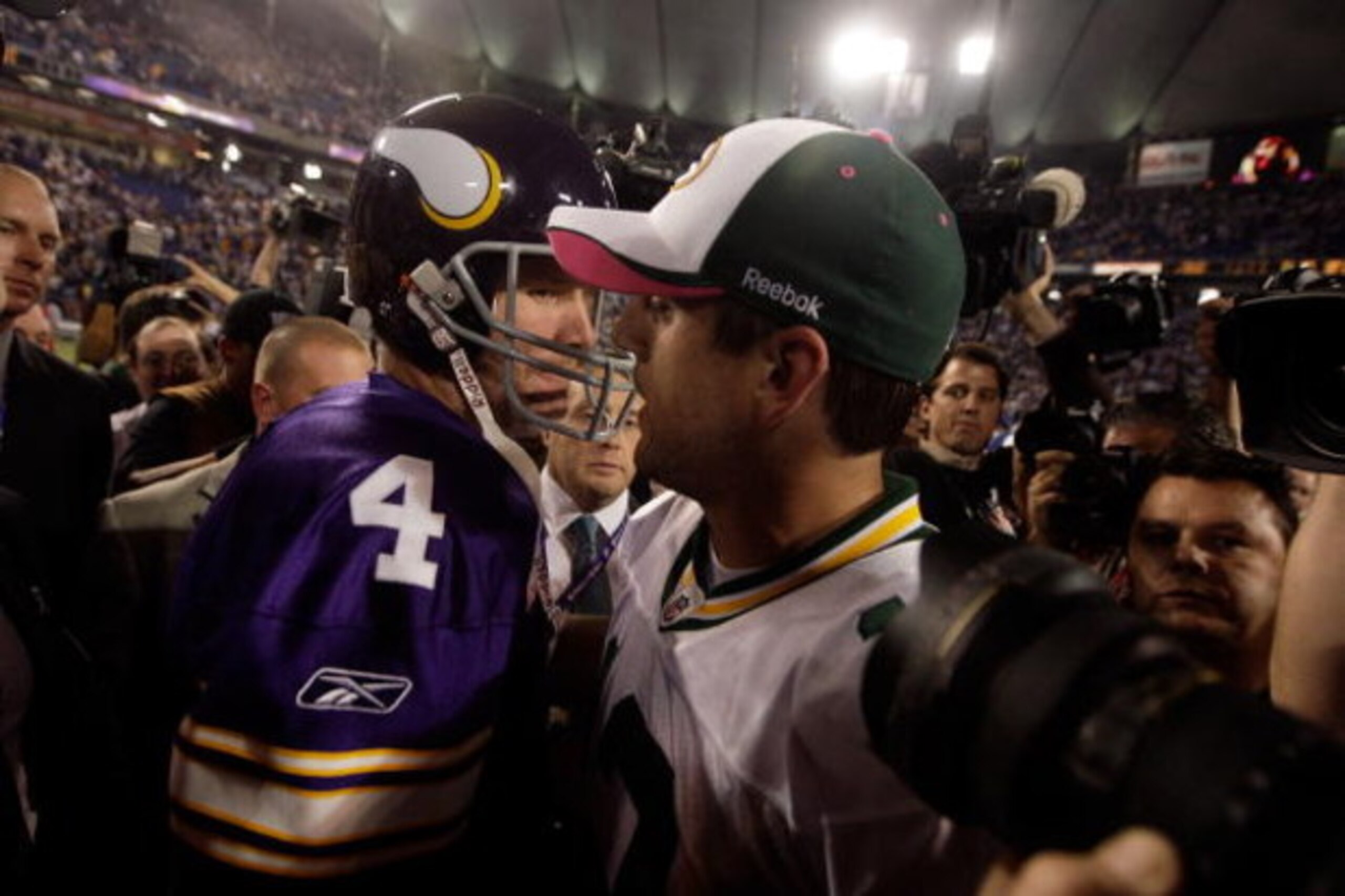 MINNEAPOLIS - OCTOBER 05:  Quarterback Brett Favre #4 of the Minnesota Vikings hugs Aaron Rodgers #12 of the Green Bay Packers following the Vikings victory over the Packers on October 5, 2009 at Hubert H. Humphrey Metrodome in Minneapolis, Minnesota.  (P