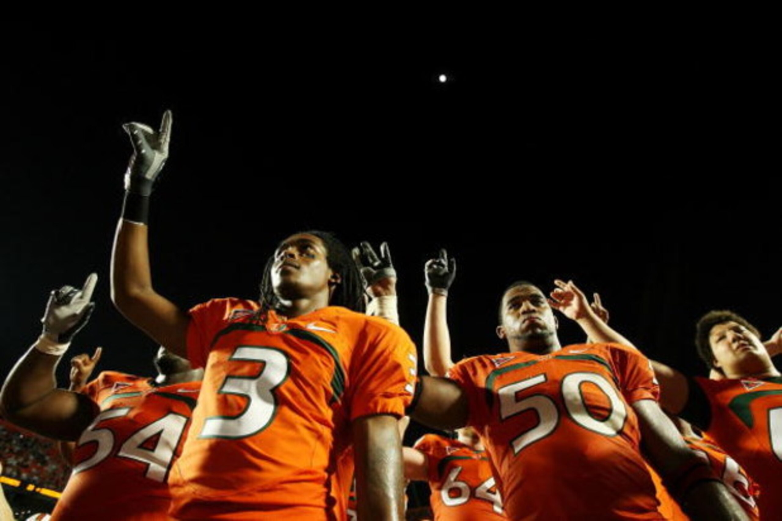 FORT LAUDERDALE, FL - OCTOBER 03: Wide receiver Travis Benjamin #3 and linebacker Darryl Sharpton #50 of the Miami Hurricanes celebrate after defeating the Oklahoma Sooners at Land Shark Stadium on October 3, 2009 in Fort Lauderdale, Florida. Miami defeat FORT LAUDERDALE, FL - OCTOBER 03: Wide receiver Travis Benjamin #3 and linebacker Darryl Sharpton #50 of the Miami Hurricanes celebrate after defeating the Oklahoma Sooners at Land Shark Stadium on October 3, 2009 in Fort Lauderdale, Florida. Miami defeat
