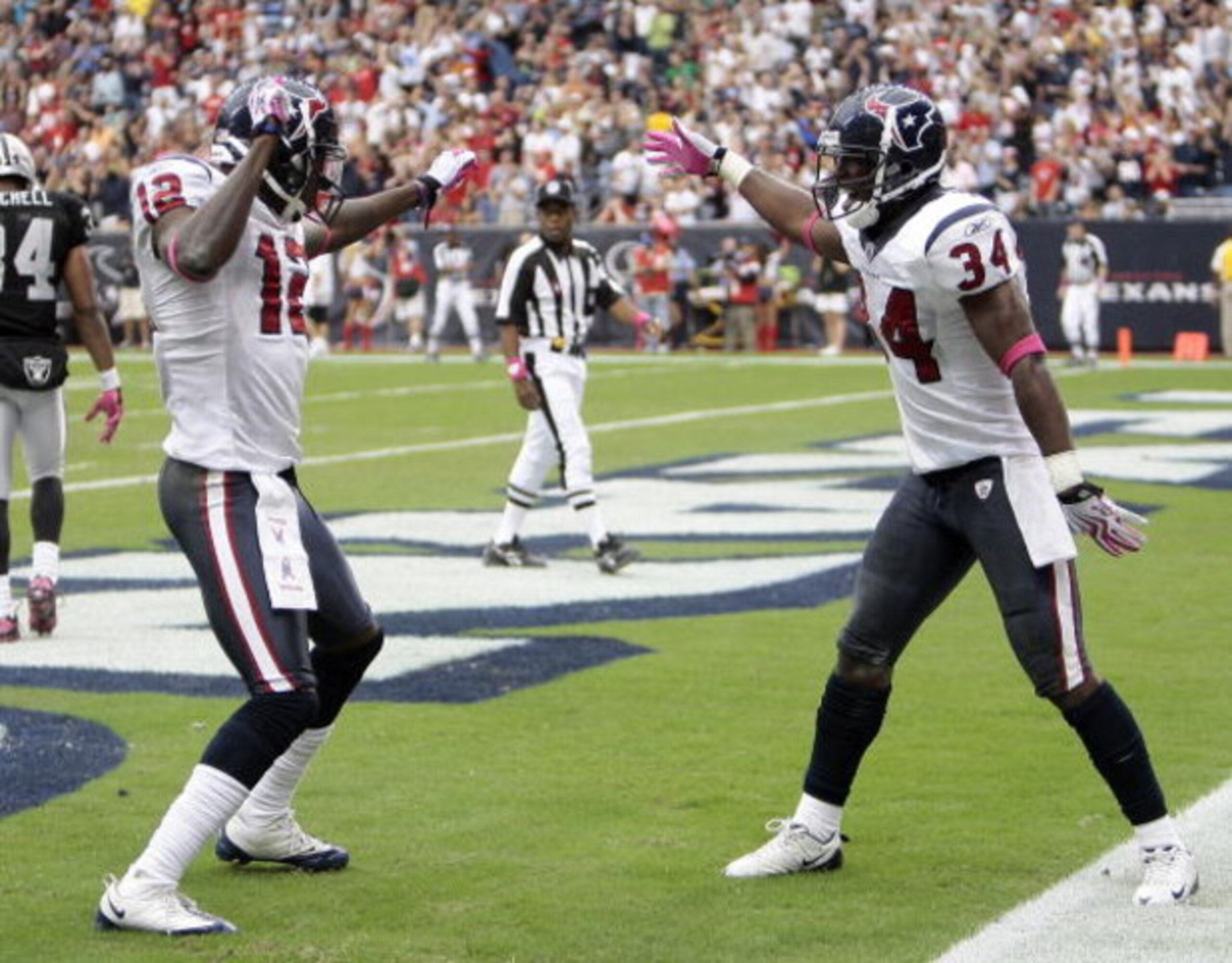 HOUSTON - OCTOBER 04:  Houston Texan Jacoby Jones #12 of the Houston Texans receives congratulations from teammate Dominique Barber #34 after his 95 yard kick return at Reliant Stadium on October 4, 2009 in Houston, Texas.  (Photo by Bob Levey/Getty Image