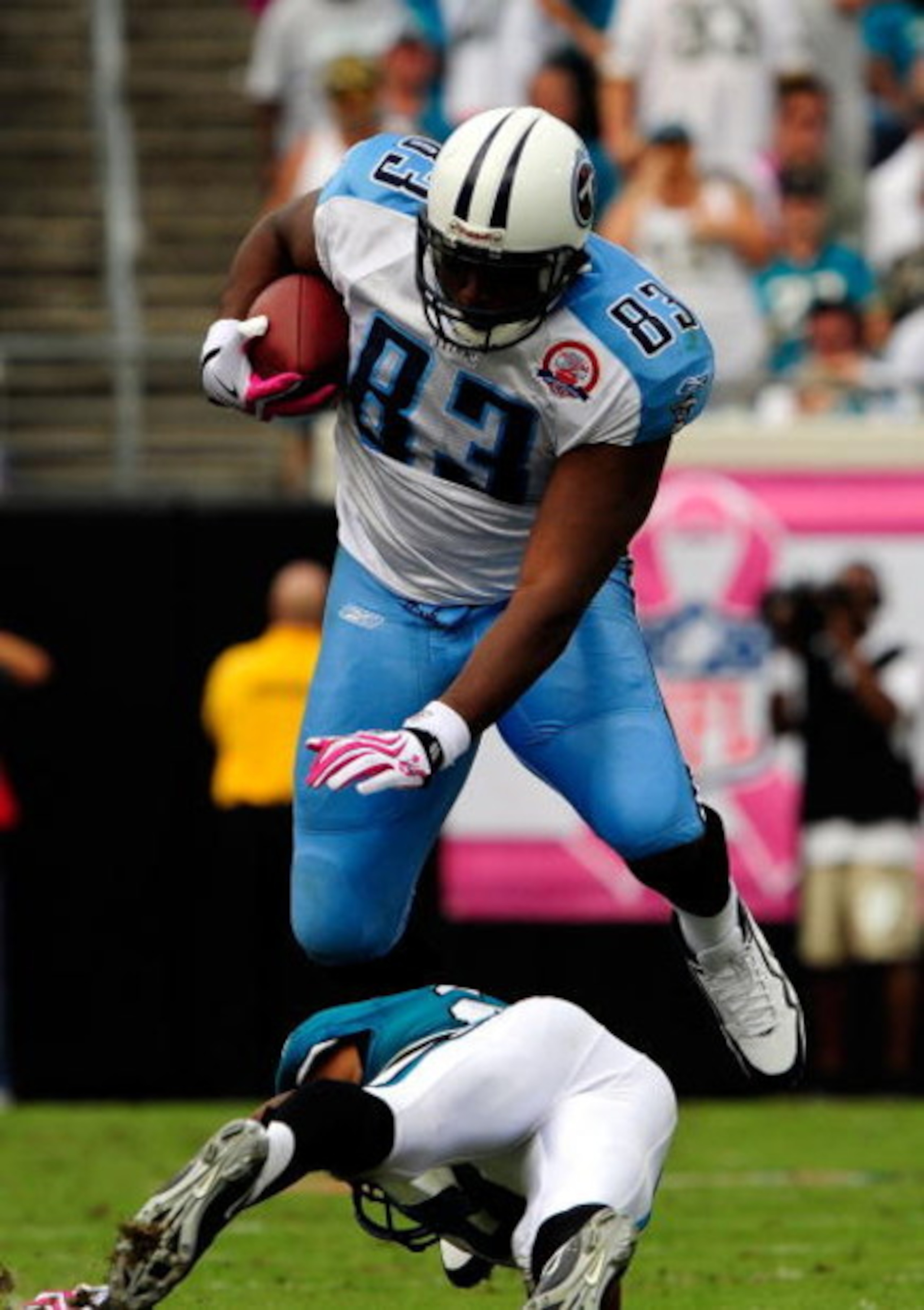 JACKSONVILLE, FL - OCTOBER 04:  Alge Crumpler #83 of the Tennessee Titans is tackled by Derek Cox #21 of the Jacksonville Jaguars at Jacksonville Municipal Stadium on October 4, 2009 in Jacksonville, Florida.  (Photo by Sam Greenwood/Getty Images)