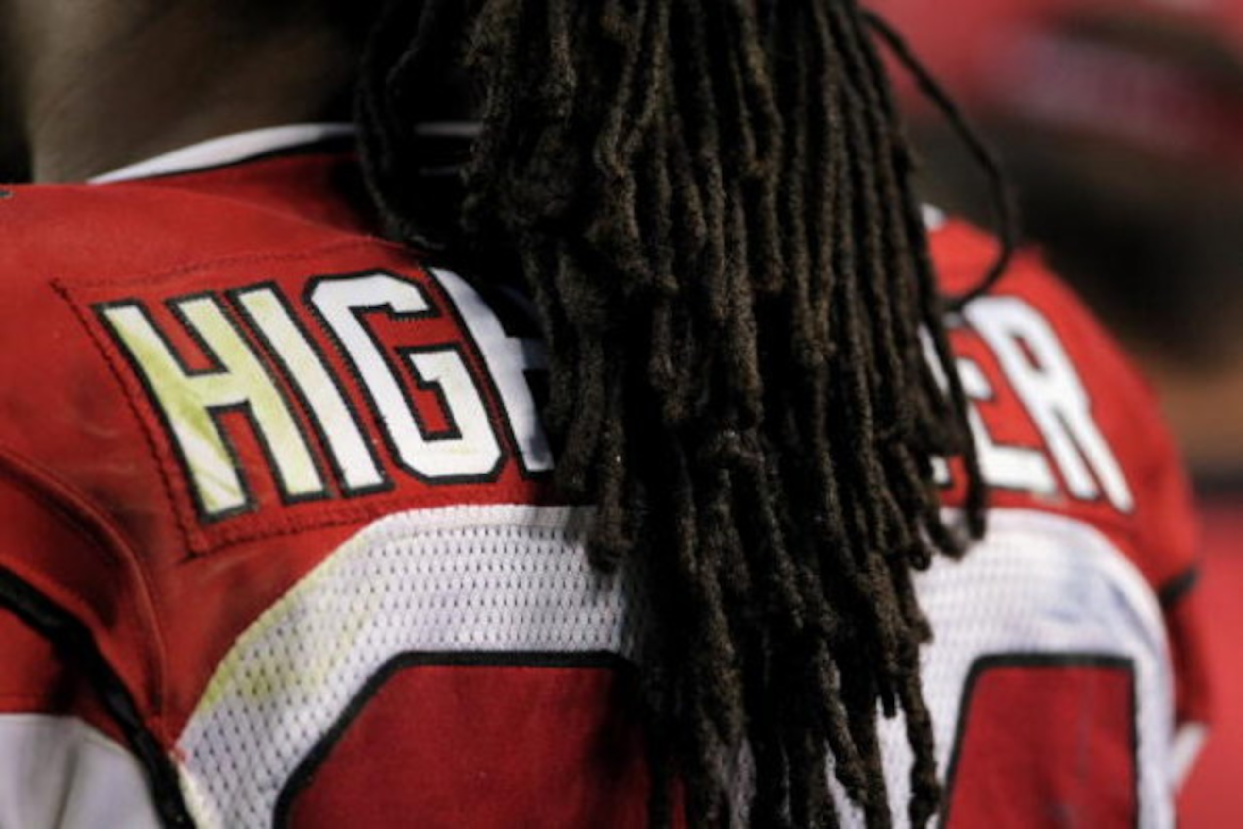 DENVER - SEPTEMBER 03:  The hair of running back Tim Hightower #34 of the Arizona Cardinals obscures the name on his jersey as he awaits action on the sidelines against the Denver Broncos during NFL preseason action at Invesco Field at Mile High on Septem
