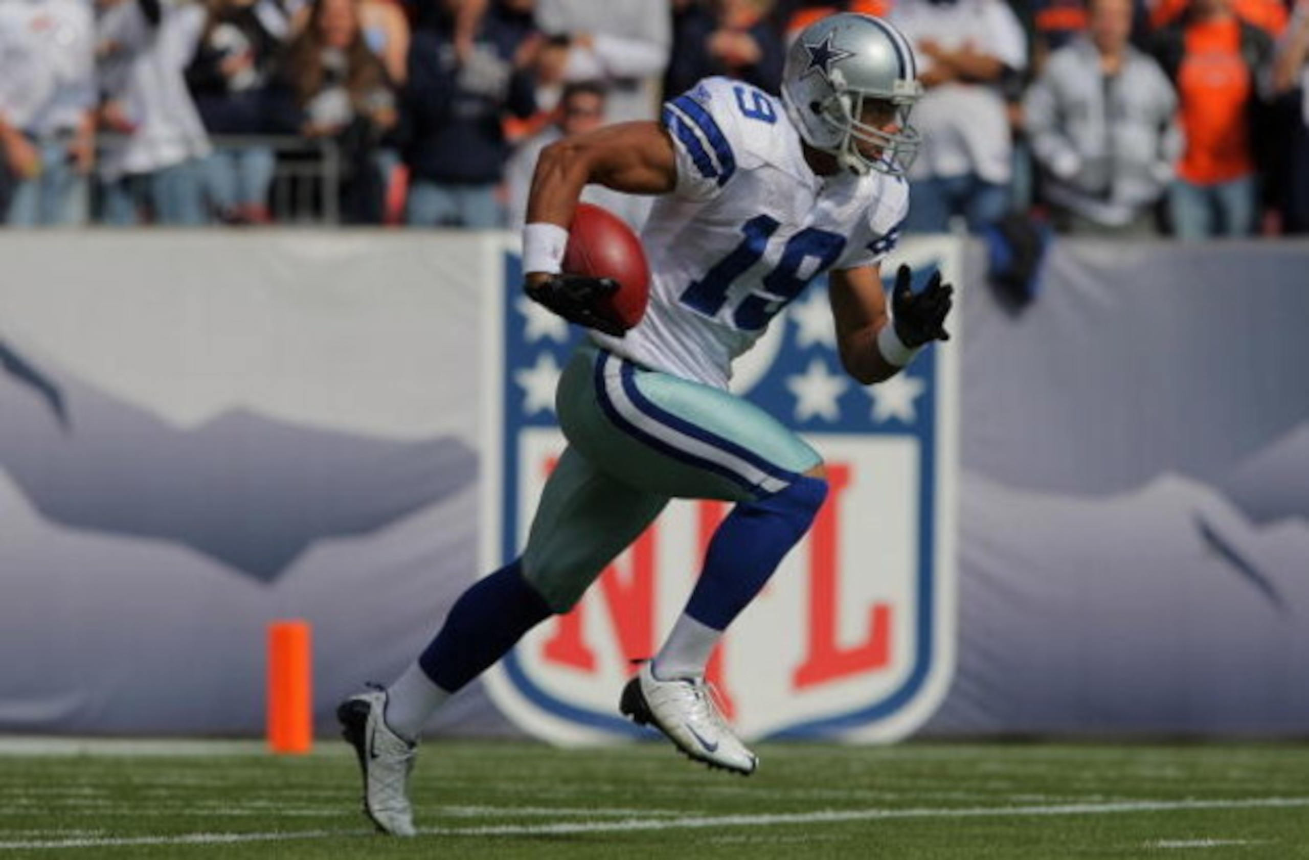 DENVER - OCTOBER 04:  Miles Austin #19 of the Dallas Cowboys rushes returns a kick off against the Denver Broncos during NFL action at Invesco Field at Mile High on October 4, 2009 in Denver, Colorado. The Broncos defeated the Cowboys 17-10.  (Photo by Do