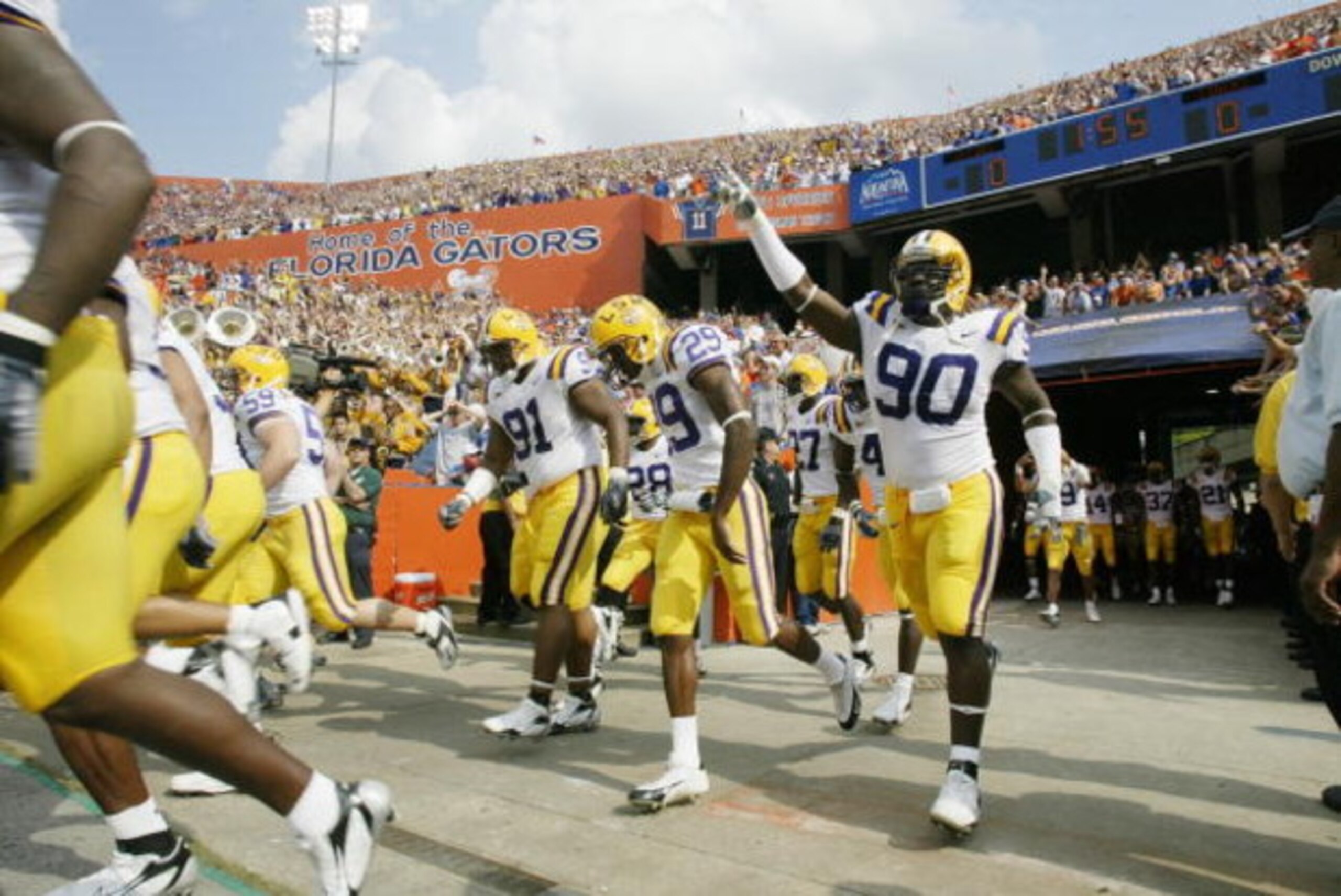 GAINESVILLE, FL - OCTOBER 7:   Charles Alexander #91, Chris Hawkins #29 and Ricky Jean-Francois #90 of the LSU Tigers run onto the field before the game against the Florida Gators at Ben Hill Griffin Stadium on October 7, 2006 in Gainesville, Florida. Flo