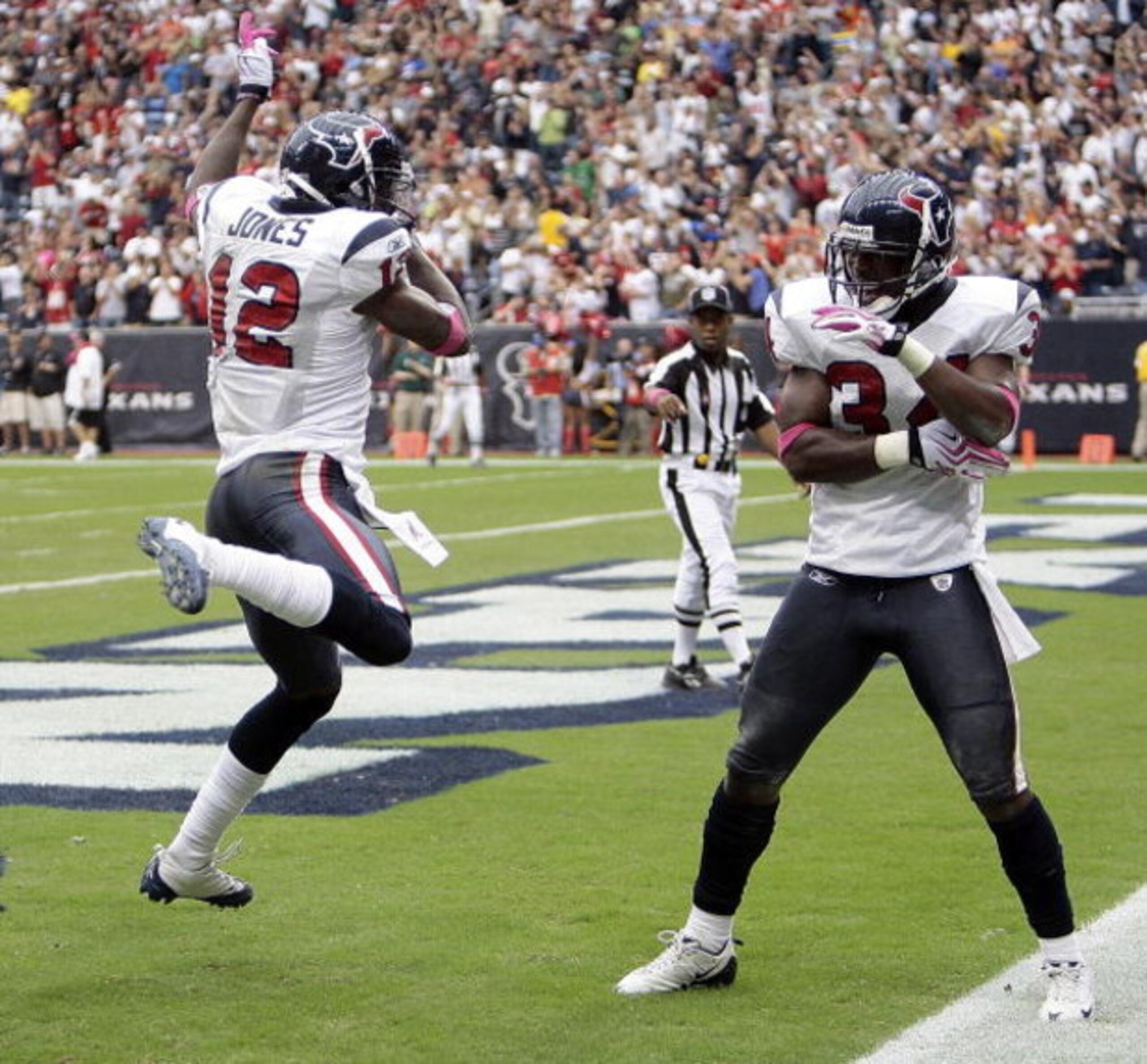 HOUSTON - OCTOBER 04:  Houston Texan Jacoby Jones #12 of the Houston Texans receives congratulations from teammate Dominique Barber #34 after his 95 yard kick return at Reliant Stadium on October 4, 2009 in Houston, Texas.  (Photo by Bob Levey/Getty Image