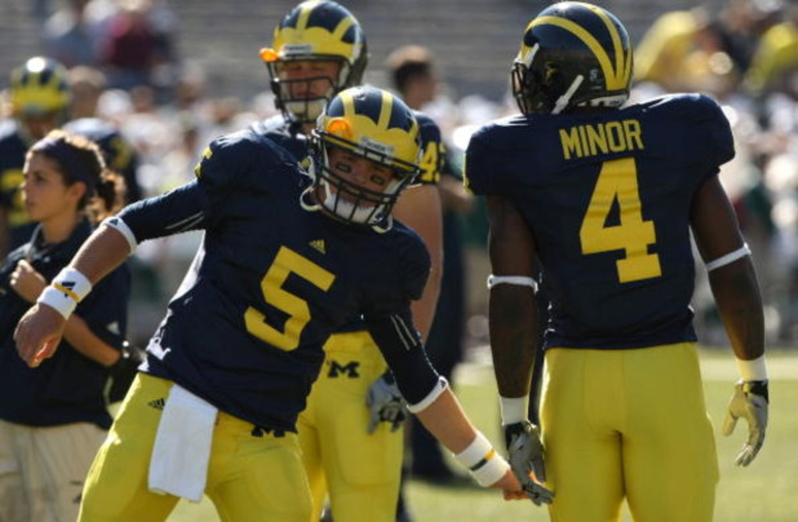ANN ARBOR, MI - SEPTEMBER 19: Quarterback Tate Forcier #5 of the Michigan Wolverines greets running back Brandon Minor #4 during warmups for the game against the Eastern Michigan Eagles at Michigan Stadium on September 19, 2009 in Ann Arbor, Michigan. M ANN ARBOR, MI - SEPTEMBER 19: Quarterback Tate Forcier #5 of the Michigan Wolverines greets running back Brandon Minor #4 during warmups for the game against the Eastern Michigan Eagles at Michigan Stadium on September 19, 2009 in Ann Arbor, Michigan. M