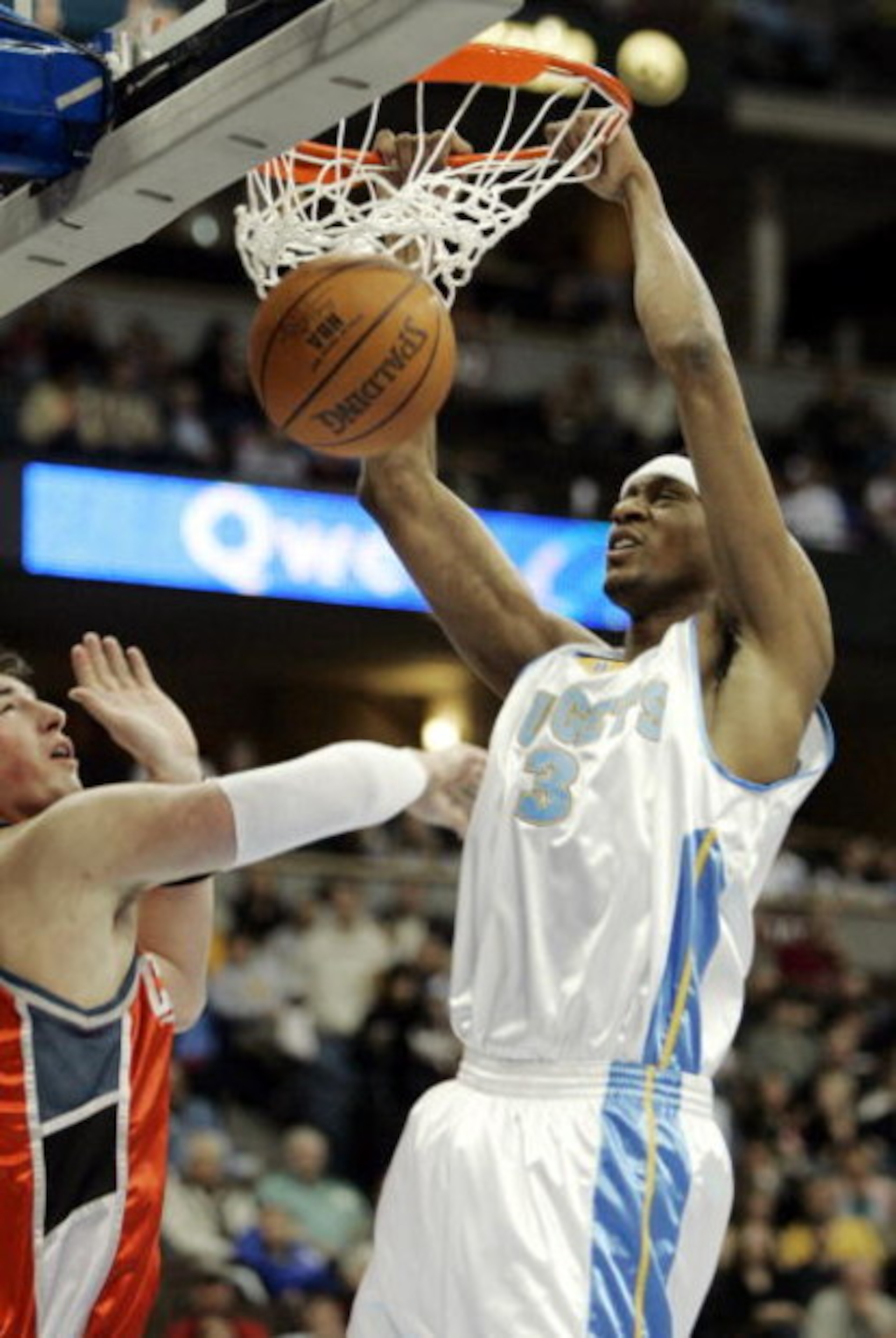 DENVER - MARCH 16:  DeMarr Johnson #3 of the Denver Nuggets dunks against the Charlotte Bobcats in first-half NBA action March 16, 2005 at the Pepsi Center in Denver, Colorado. NOTE TO USER: User expressly acknowledges and agrees that, by downloading and/