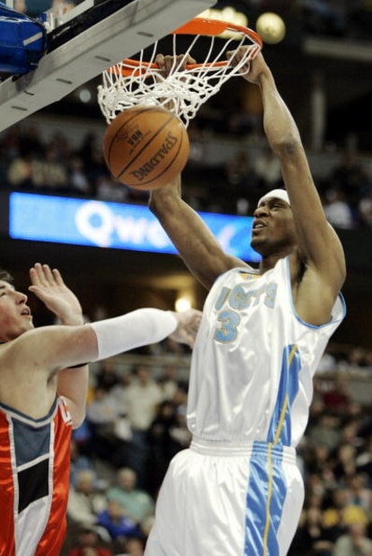 DENVER - MARCH 16:  DeMarr Johnson #3 of the Denver Nuggets dunks against the Charlotte Bobcats in first-half NBA action March 16, 2005 at the Pepsi Center in Denver, Colorado. NOTE TO USER: User expressly acknowledges and agrees that, by downloading and/