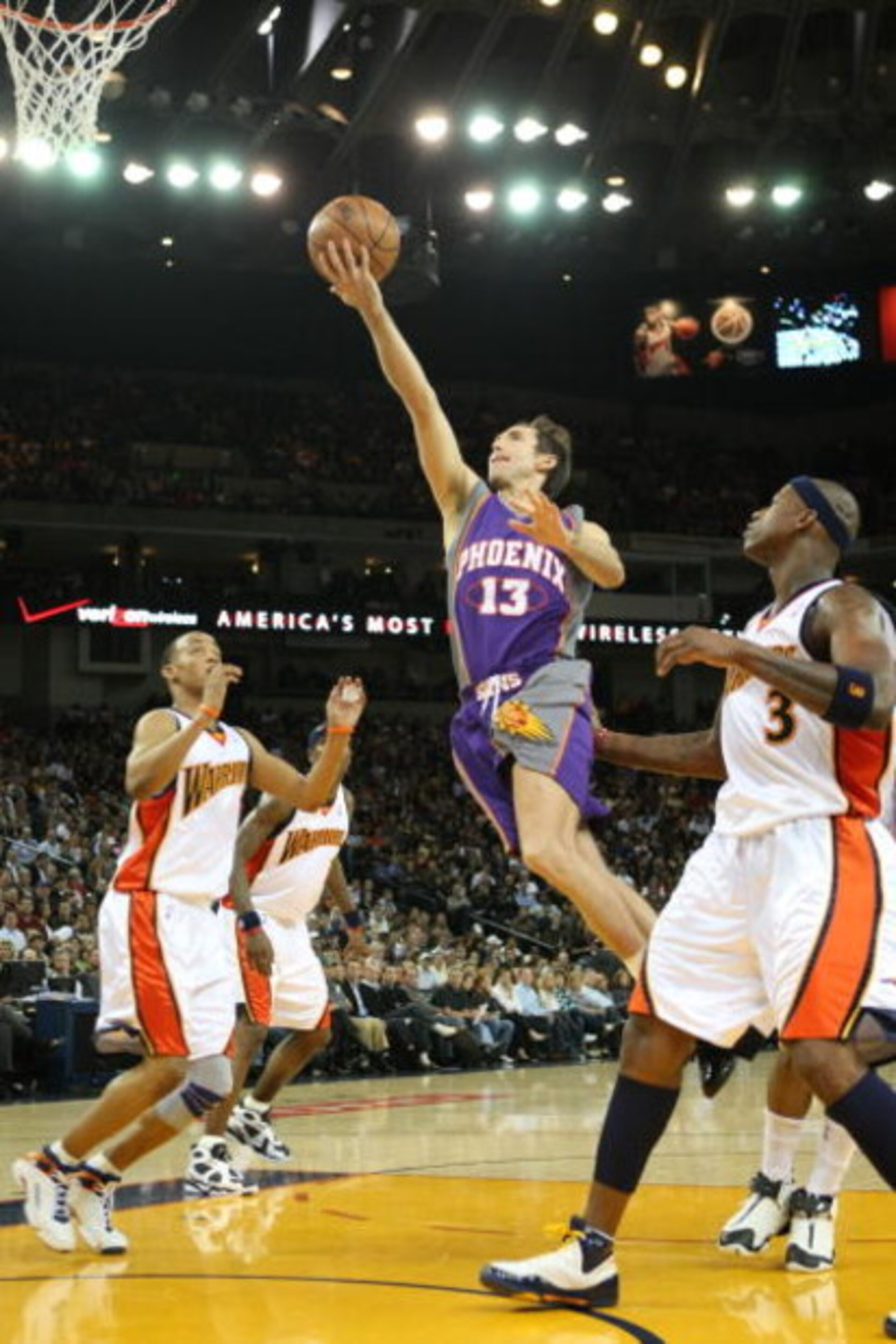 OAKLAND, CA - FEBRUARY 13: Steve Nash #13 of the Phoenix Suns shoots over Monta Ellis 38 and Al Harrington #3 of the Golden State Warriors during an NBA game on February 13, 2008 at Oracle Arena in Oakland, California. NOTE TO USER: User expressly acknowl OAKLAND, CA - FEBRUARY 13: Steve Nash #13 of the Phoenix Suns shoots over Monta Ellis 38 and Al Harrington #3 of the Golden State Warriors during an NBA game on February 13, 2008 at Oracle Arena in Oakland, California. NOTE TO USER: User expressly acknowl