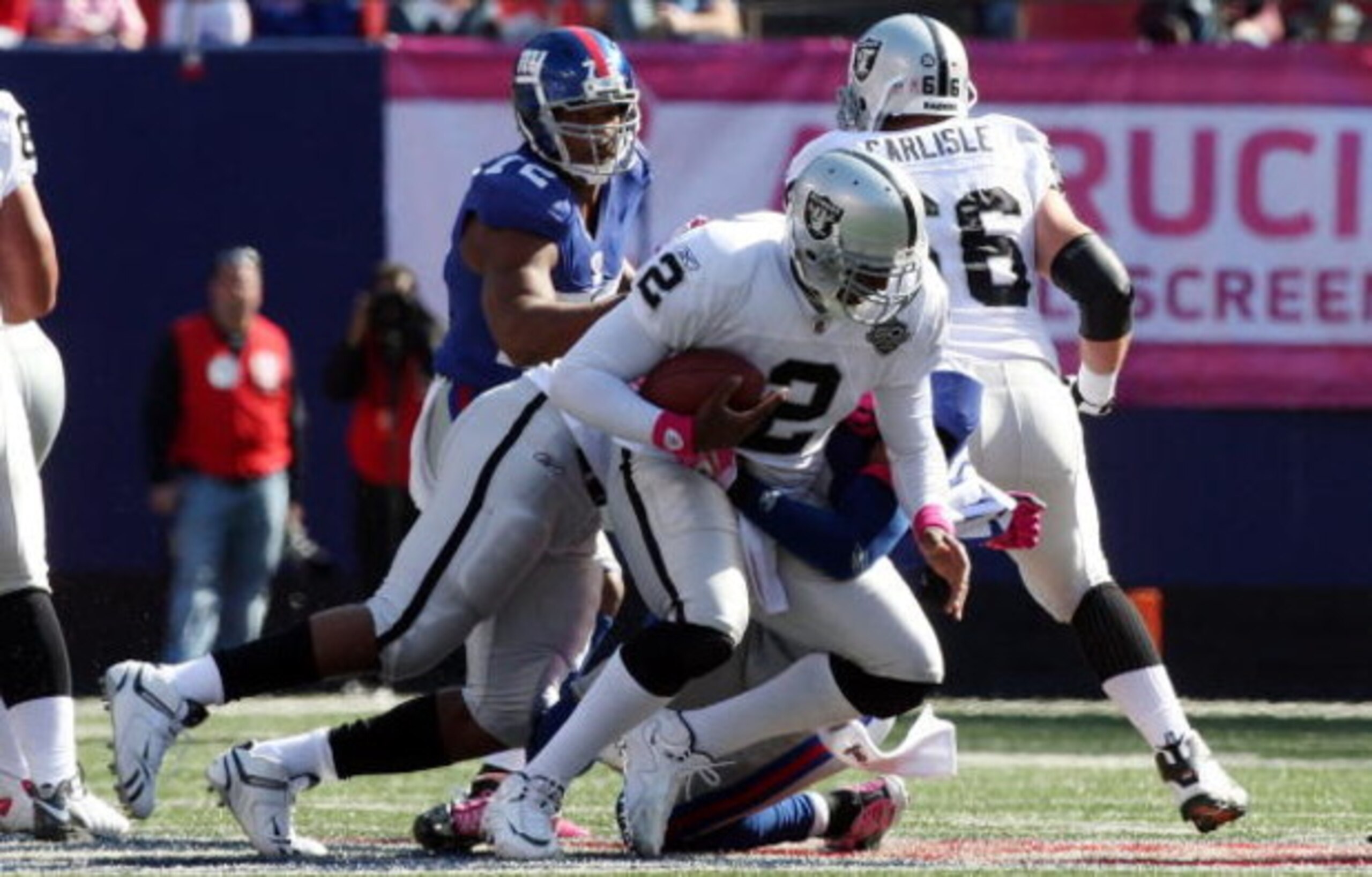 EAST RUTHERFORD, NJ - OCTOBER 11: JaMarcus Russell #2 of the Oakland Raiders is sacked by Michael Johnson #20 of the New York Giants on October 11, 2009 at Giants Stadium in East Rutherford, New Jersey. (Photo by Jim McIsaac/Getty Images) EAST RUTHERFORD, NJ - OCTOBER 11: JaMarcus Russell #2 of the Oakland Raiders is sacked by Michael Johnson #20 of the New York Giants on October 11, 2009 at Giants Stadium in East Rutherford, New Jersey. (Photo by Jim McIsaac/Getty Images)