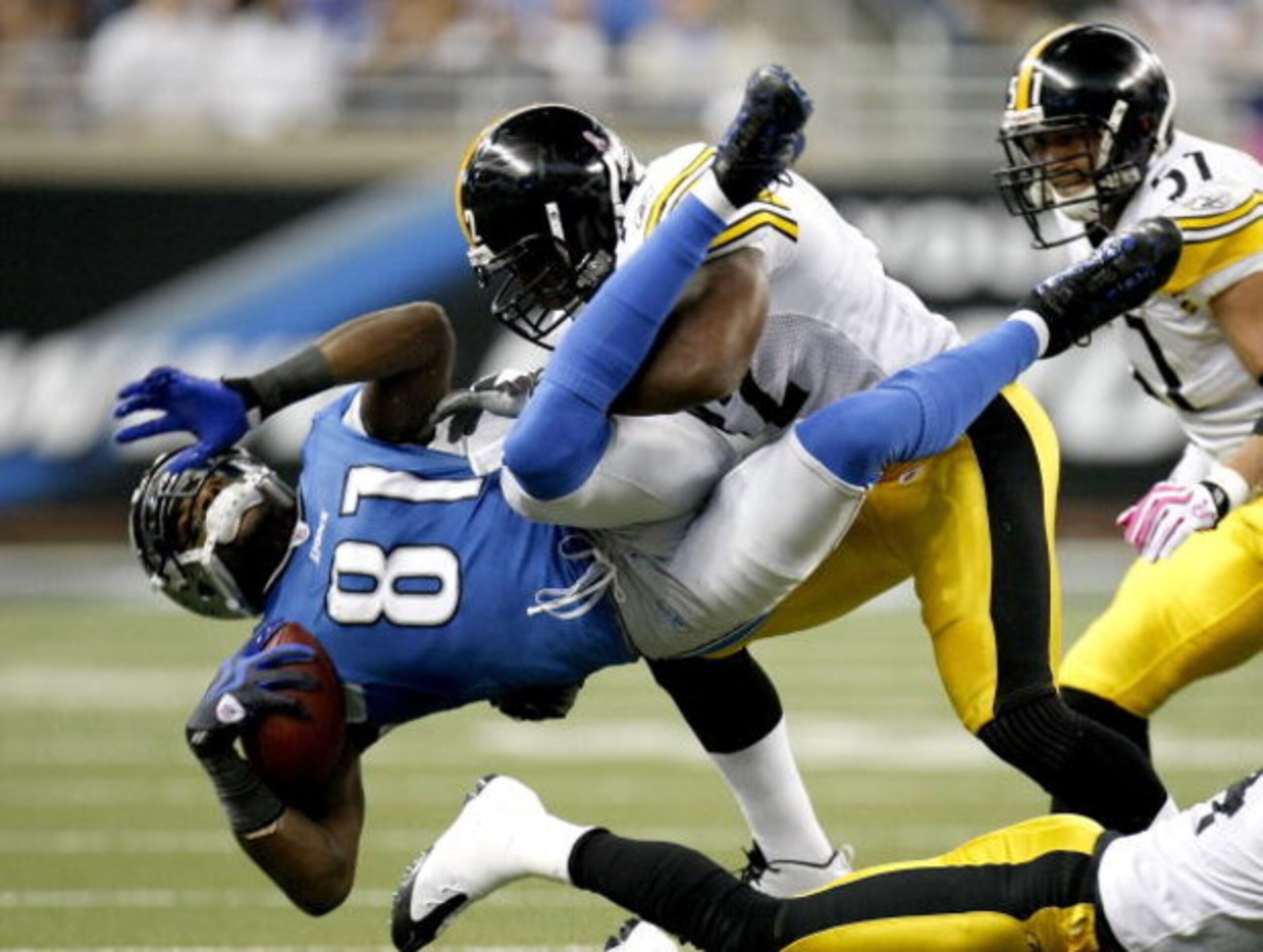 DETROIT , MI - OCTOBER 11: Calvin Johnson #81 of the Detroit Lions is tackled by James Harrison #92 of the Pittsburgh Steelers October 11, 2009 at Ford Field in Detroit, Michigan. Johnson was injured on the play. (Photo by Gregory Shamus/Getty Images) DETROIT , MI - OCTOBER 11: Calvin Johnson #81 of the Detroit Lions is tackled by James Harrison #92 of the Pittsburgh Steelers October 11, 2009 at Ford Field in Detroit, Michigan. Johnson was injured on the play. (Photo by Gregory Shamus/Getty Images)