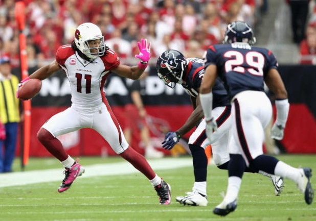 GLENDALE, AZ - OCTOBER 11:  Wide receiver Larry Fitzgerald #11 of the Arizona Cardinals runs with the ball after a reception past Bernard Pollard #31 of the Houston Texans during the NFL game at the Universtity of Phoenix Stadium on October 11, 2009 in Gl