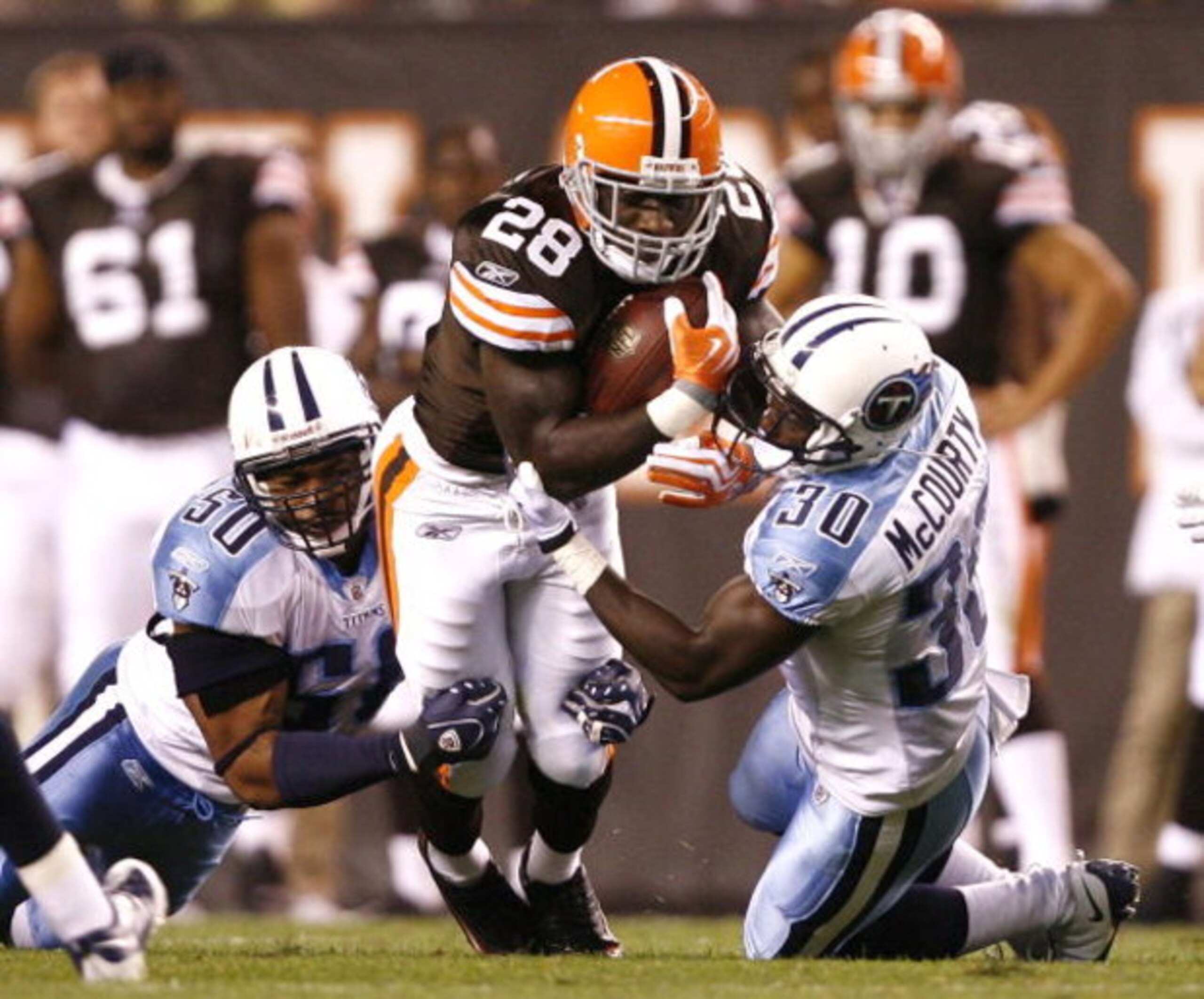 CLEVELAND - AUGUST 29:  James Davis #28 of the Cleveland Browns is hit by David Thornton #50 and Jason McCourty #30 of the Tennessee Titans at Cleveland Browns Stadium on August 29, 2009 in Cleveland, Ohio.  (Photo by Matt Sullivan/Getty Images)
