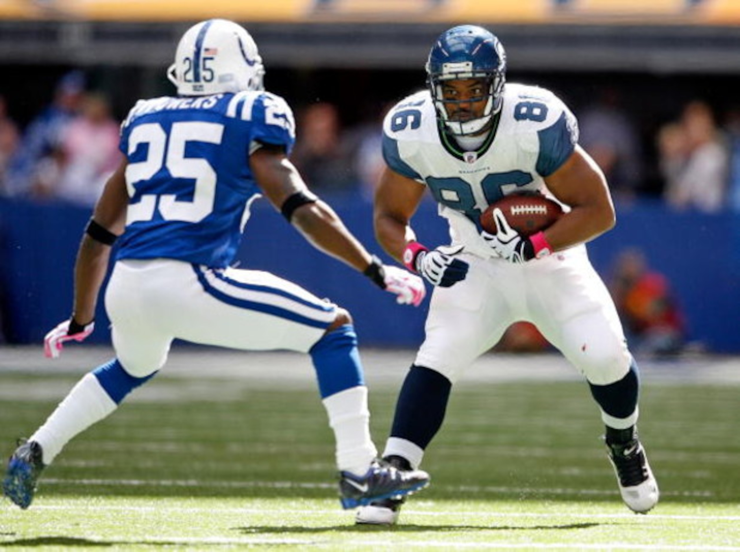 INDIANAPOLIS - OCTOBER 04:  John Owens #86 of the Seattle Seahawks runs with the ball while defended by Jerraud Powers #25 of the Indianapolis Colts during the NFL game at Lucas Oil Stadium on October 4, 2009 in Indianapolis, Indiana.  (Photo by Andy Lyon
