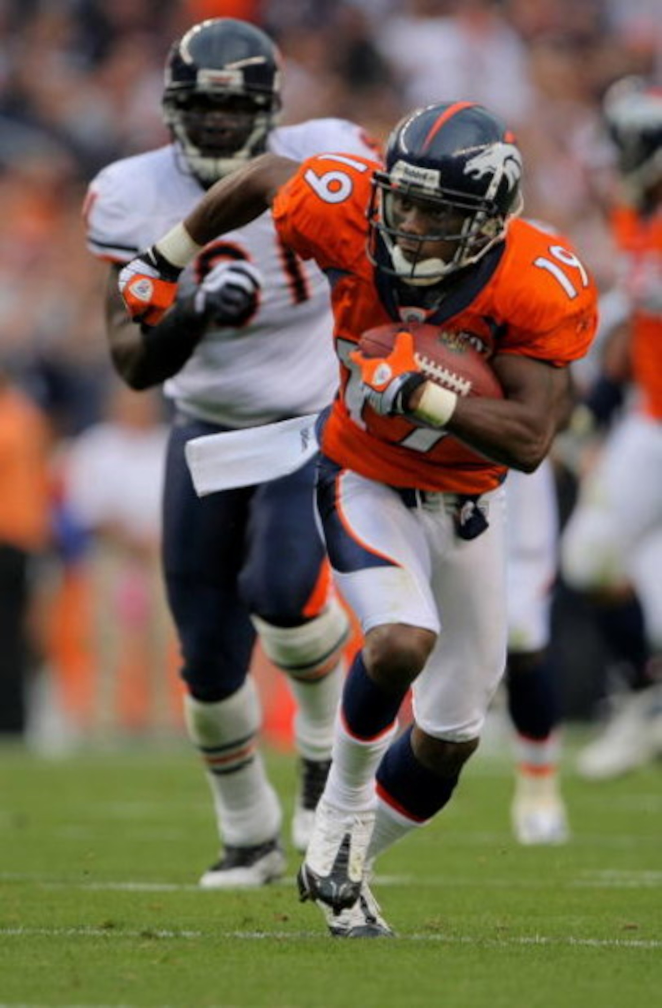 DENVER - AUGUST 30:  Wide reciever Eddie Royal #19 of the Denver Broncos makes a reception and and picks up yardage against the Chicago Bears during preseason NFL action at INVESCO Field at Mile High on August 30, 2009 in Denver, Colorado. The Bears defea