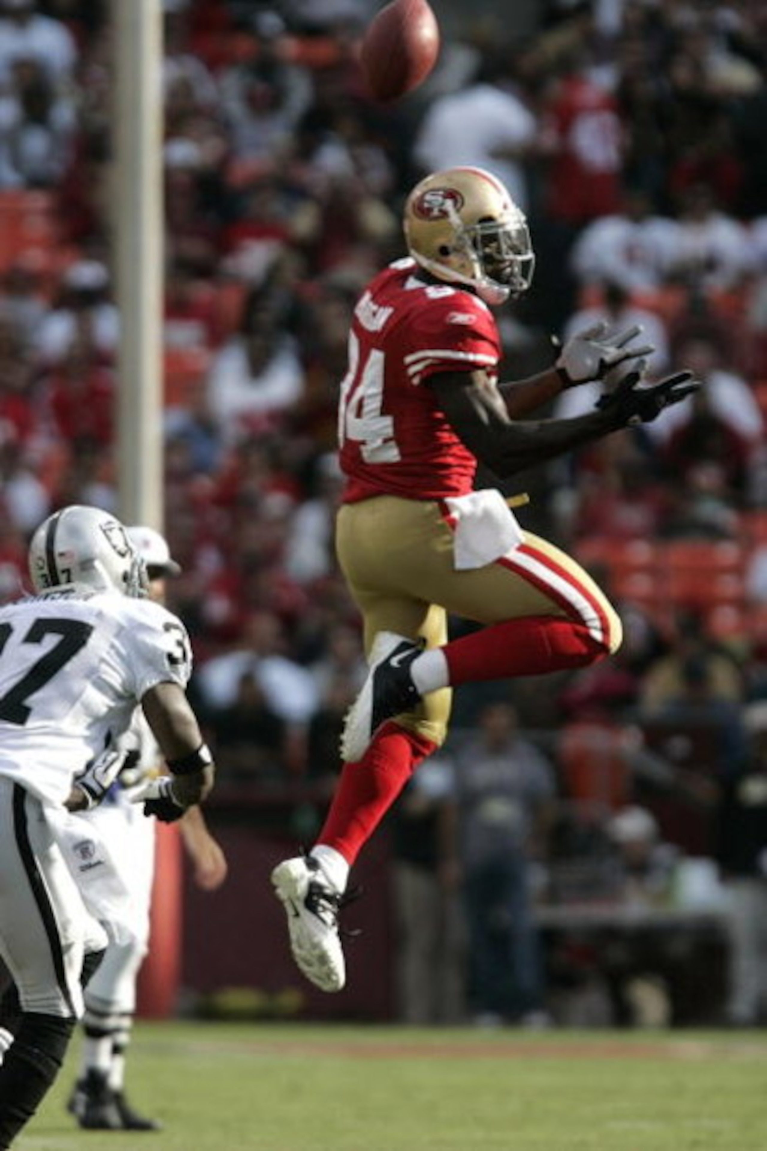 SAN FRANCISCO - AUGUST 22:   San Francisco 49ers wide receiver Josh Morgan #84 goes up for the ball as Oakland Raiders cornerback Chris Johnson #37 defends during the 1st quarter as the San Francisco 49ers host the Oakland Raiders at Candlestick Park Augu