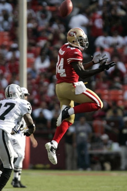SAN FRANCISCO - AUGUST 22:   San Francisco 49ers wide receiver Josh Morgan #84 goes up for the ball as Oakland Raiders cornerback Chris Johnson #37 defends during the 1st quarter as the San Francisco 49ers host the Oakland Raiders at Candlestick Park Augu