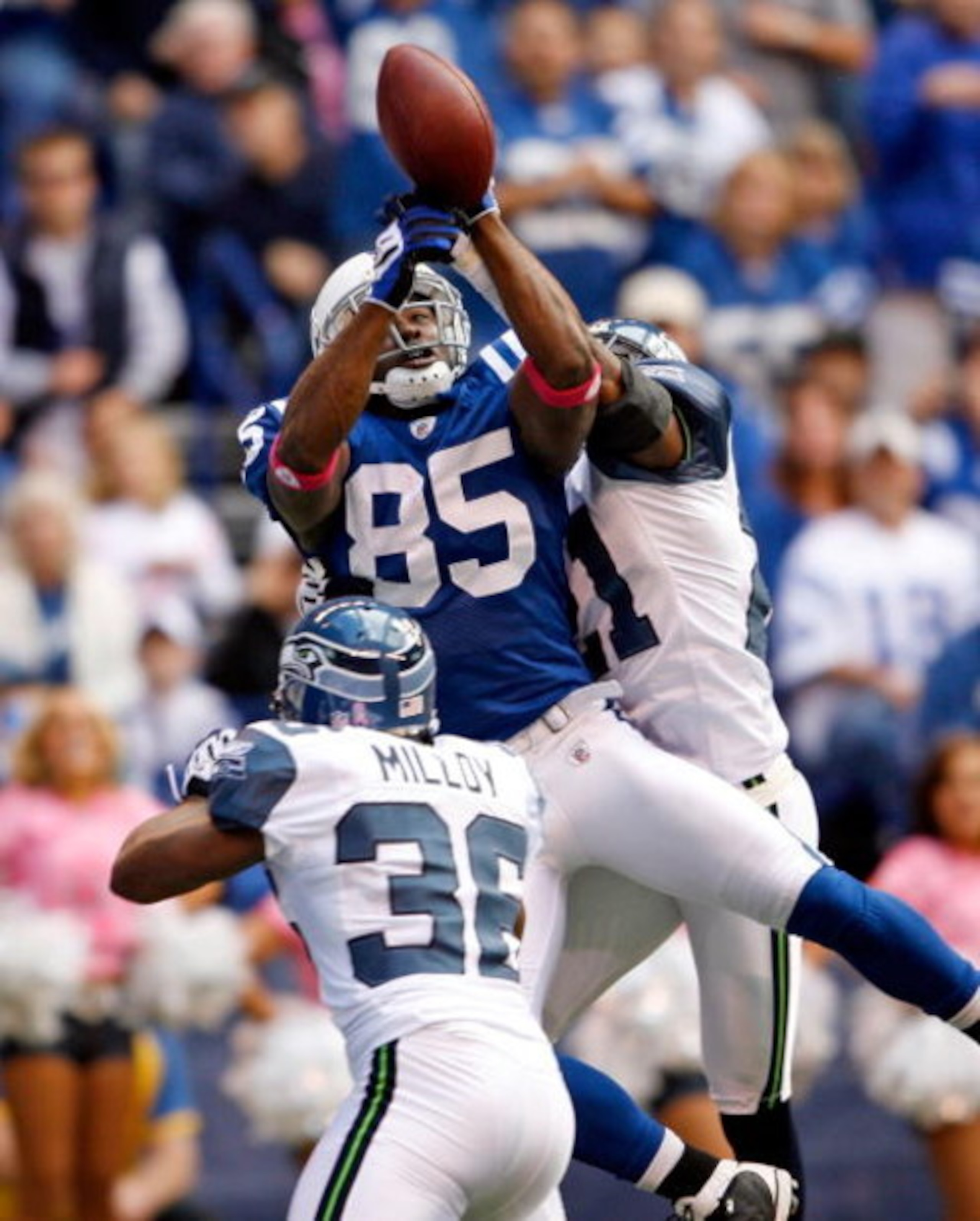INDIANAPOLIS - OCTOBER 04:  Pierre Garcon #85 of the Indianapolis Colts reaches up for the ball while defended by Kelly Jennings #21 of the Seattle Seahawks at Lucas Oil Stadium on October 4, 2009 in Indianapolis, Indiana. The Colts won 34-17.  (Photo by 