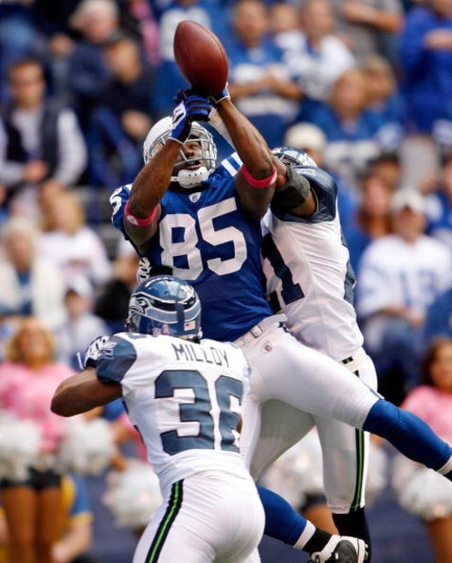 INDIANAPOLIS - OCTOBER 04:  Pierre Garcon #85 of the Indianapolis Colts reaches up for the ball while defended by Kelly Jennings #21 of the Seattle Seahawks at Lucas Oil Stadium on October 4, 2009 in Indianapolis, Indiana. The Colts won 34-17.  (Photo by 