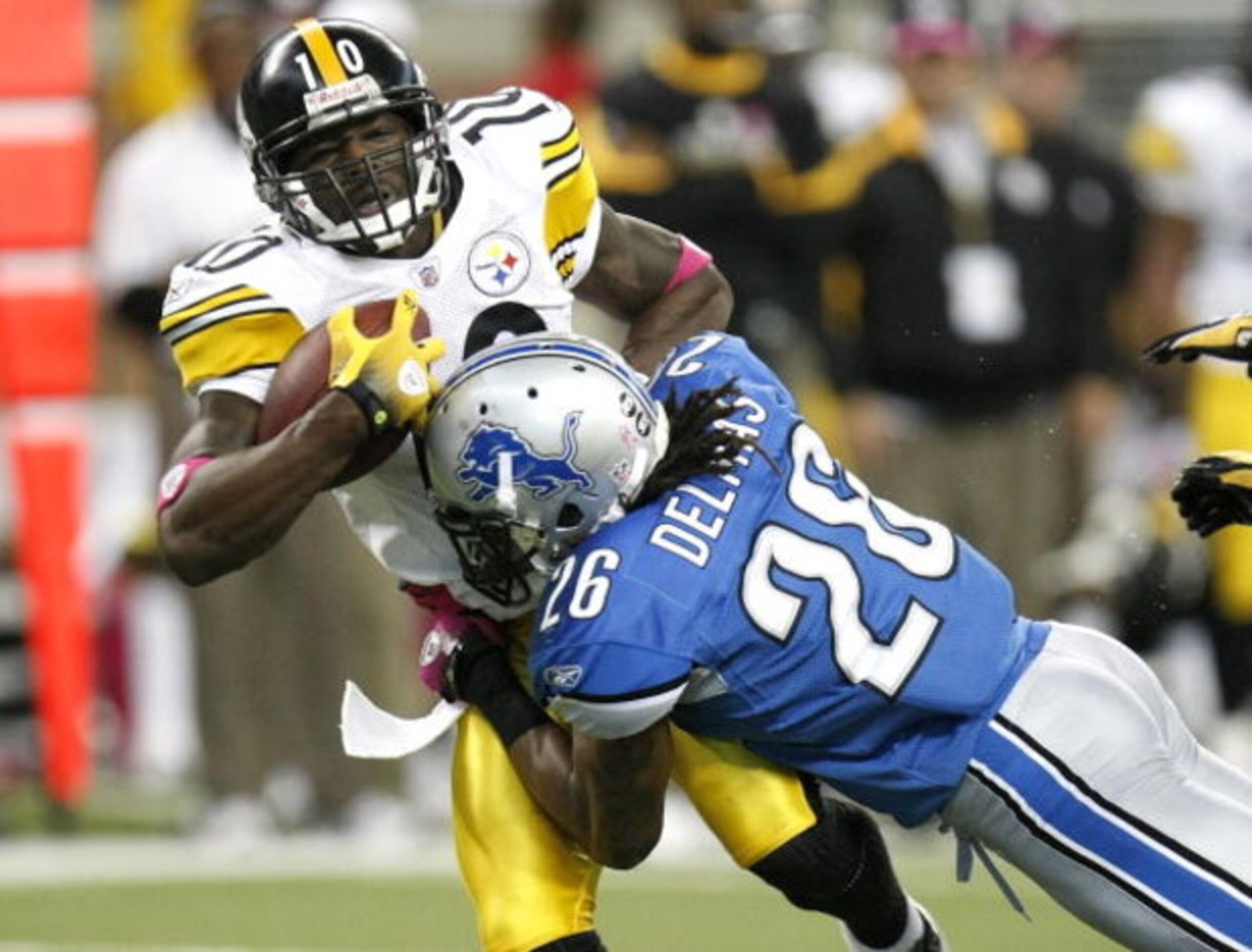 DETROIT , MI - OCTOBER 11: Santonio Holmes #10 of the Pittsburgh Steelers is tackled after making a second quarter catch by Louis Delmas #28 of the Detroit Lions on October 11, 2009 at Ford Field in Detroit, Michigan.  (Photo by Gregory Shamus/Getty Image