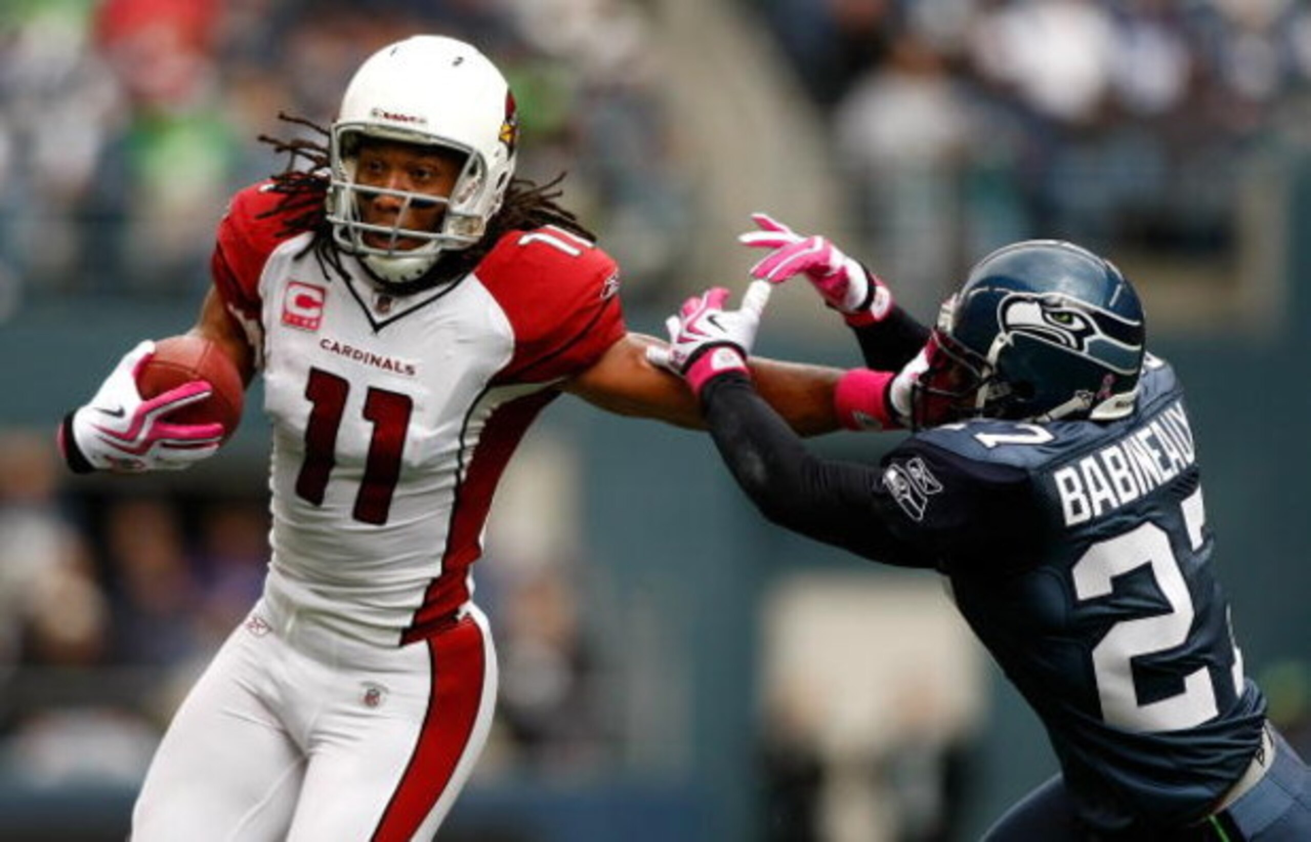 SEATTLE, WA - OCTOBER 18: Larry Fitzgerald #11 of the Arizona Cardinals breaks a tackle by Jordan Babineaux #27 of the Seattle Seahawks at Qwest Field on October 18, 2009 in Seattle, Washington. (Photo by Jonathan Ferrey/Getty Images) SEATTLE, WA - OCTOBER 18: Larry Fitzgerald #11 of the Arizona Cardinals breaks a tackle by Jordan Babineaux #27 of the Seattle Seahawks at Qwest Field on October 18, 2009 in Seattle, Washington. (Photo by Jonathan Ferrey/Getty Images)