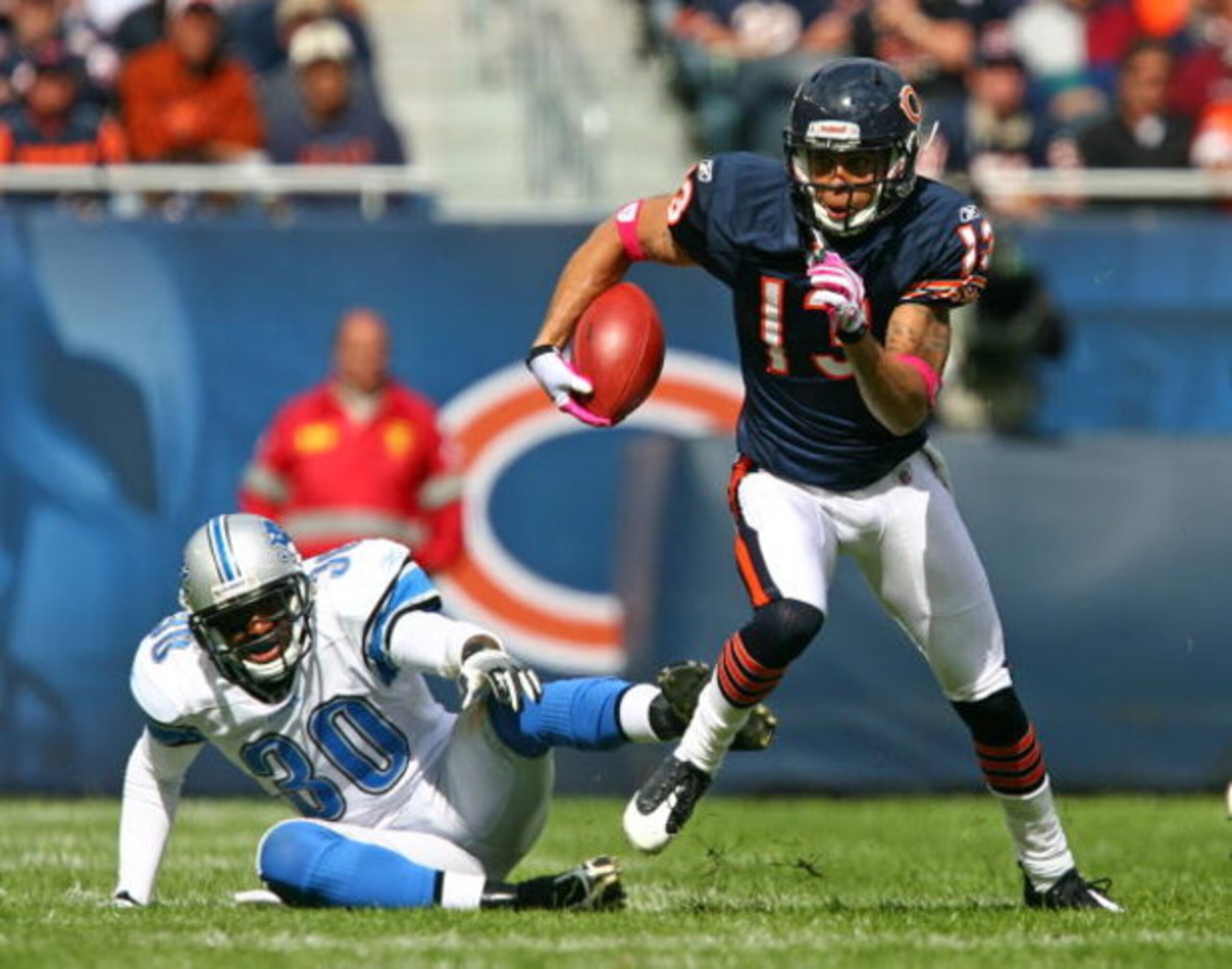 CHICAGO - OCTOBER 04: Johnny Knox #13 of the Chicago Bears runs past Ko Simpson #30 of the Detroit Lions on October 4, 2009 at Soldier Field in Chicago, Illinois. The Bears defeated the Lions 48-24. (Photo by Jonathan Daniel/Getty Images) CHICAGO - OCTOBER 04: Johnny Knox #13 of the Chicago Bears runs past Ko Simpson #30 of the Detroit Lions on October 4, 2009 at Soldier Field in Chicago, Illinois. The Bears defeated the Lions 48-24. (Photo by Jonathan Daniel/Getty Images)