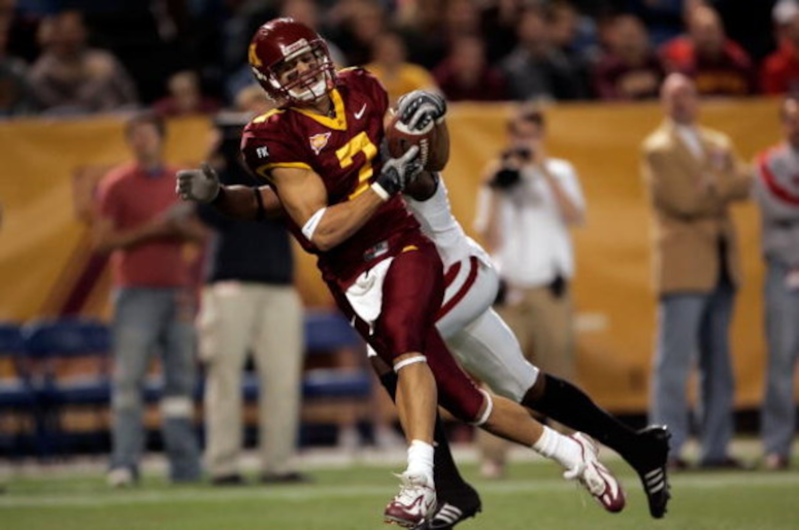 MINNEAPOLIS - NOVEMBER 17:  Wide receiver Eric Decker #7 of the Minnesota Golden Gophers catches a pass for a touchdown while being defended by Jack Ikegwuonu #6 of the Wisconsin Badgers in the second quarter at the Hubert H. Humphrey Metrodome November 1