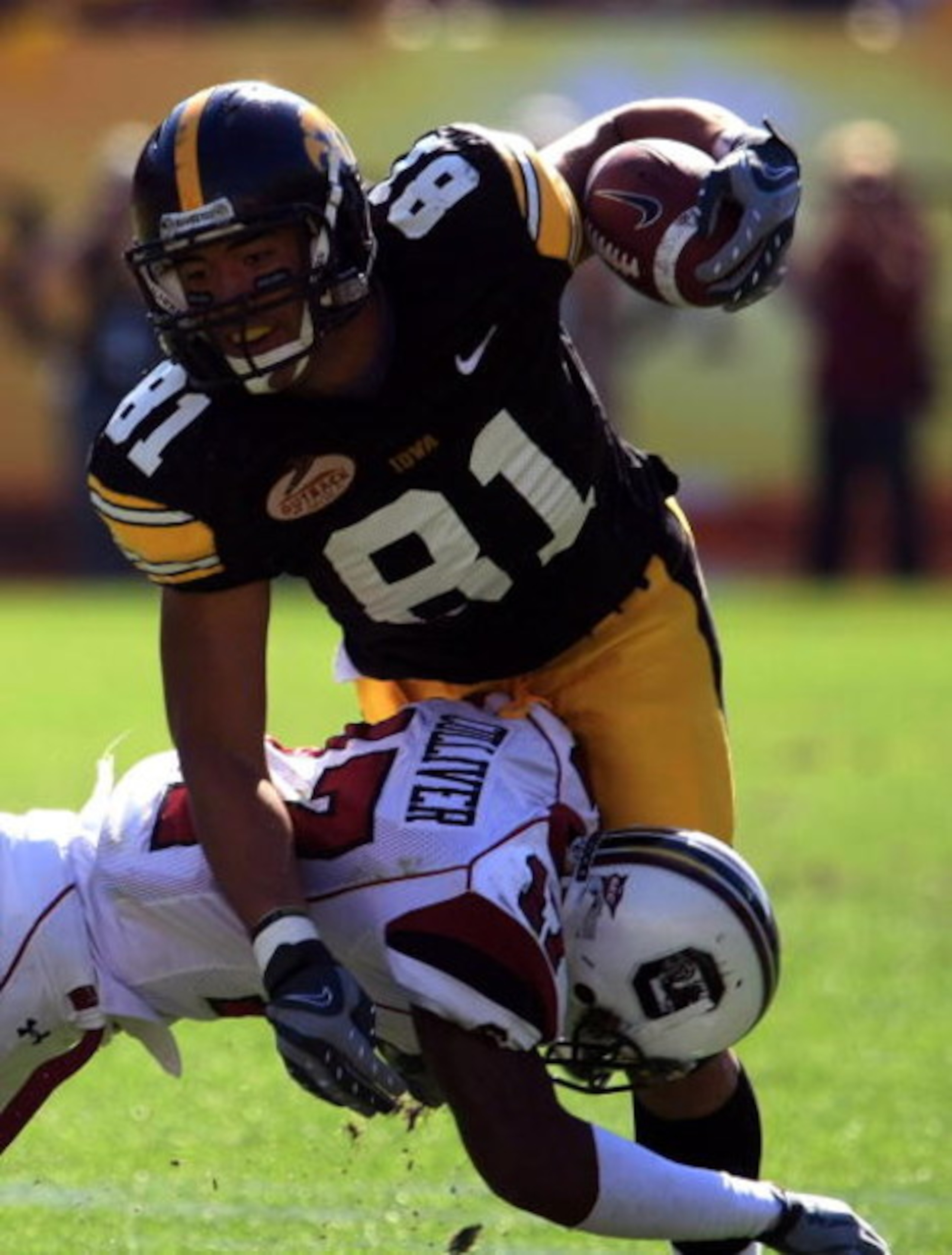 TAMPA, FL - JANUARY 01:  Tony Moeaki #81 of the Iowa Hawkeyes runs upfield as he fights off the tackle of Chris Culliver #17 of the South Carolina Gamecocks during the Outback Bowl on January 1, 2009 at Raymond James Stadium in Tampa, Florida.  (Photo by 
