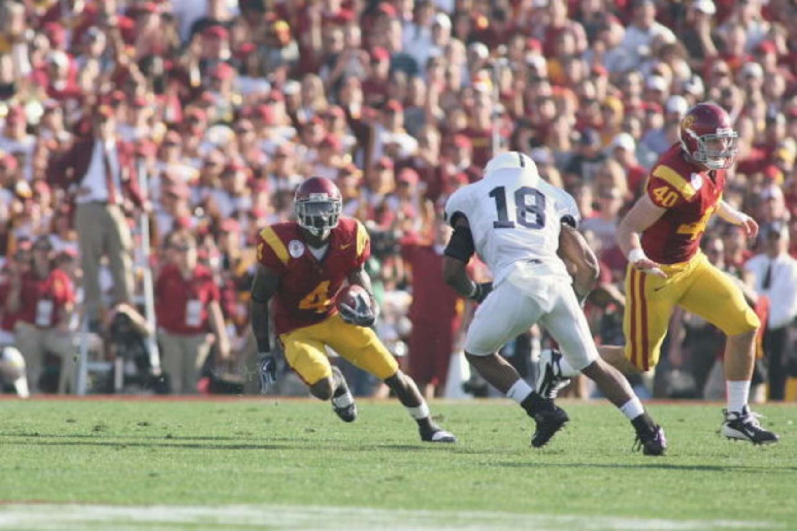PASADENA, CA - JANUARY 1:  Joe McKnight #4 of the USC Trojans carries the ball against Navorro Bowman #18 of the Penn State Nittany Lions on January 1, 2009 at the Rose Bowl in Pasadena, California.  USC won 38-24.  (Photo by Jeff Golden/Getty Images) 