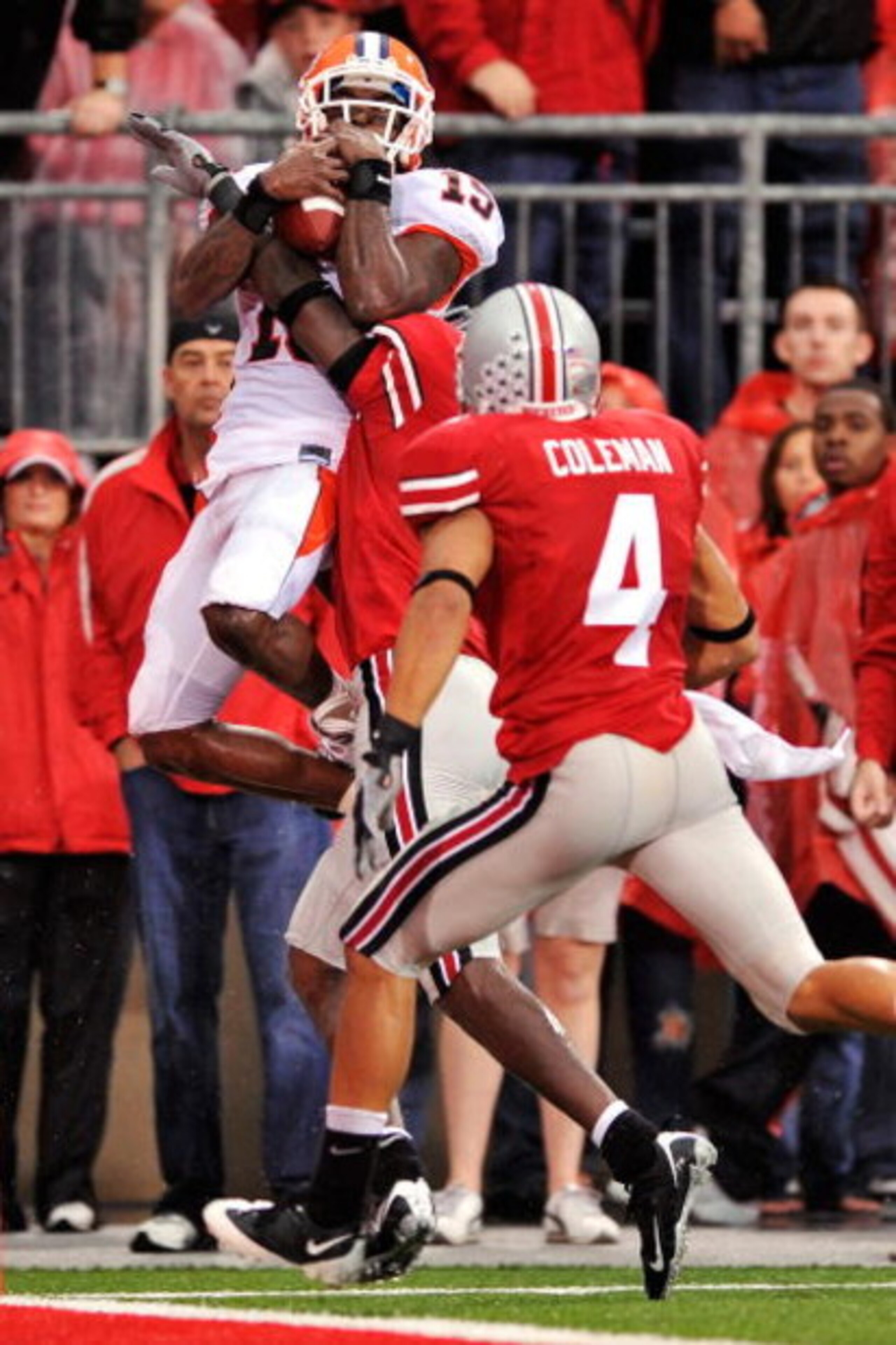 COLUMBUS, OH - SEPTEMBER 26:  Wide receiver Chris Duvalt #15 of the Illinois Fighting Illini hauls in a long pass but is forced out of bounds by Chimdi Chekwa #5 and Kurt Coleman #4 of the Ohio State Buckeyes at Ohio Stadium on September 26, 2009 in Colum