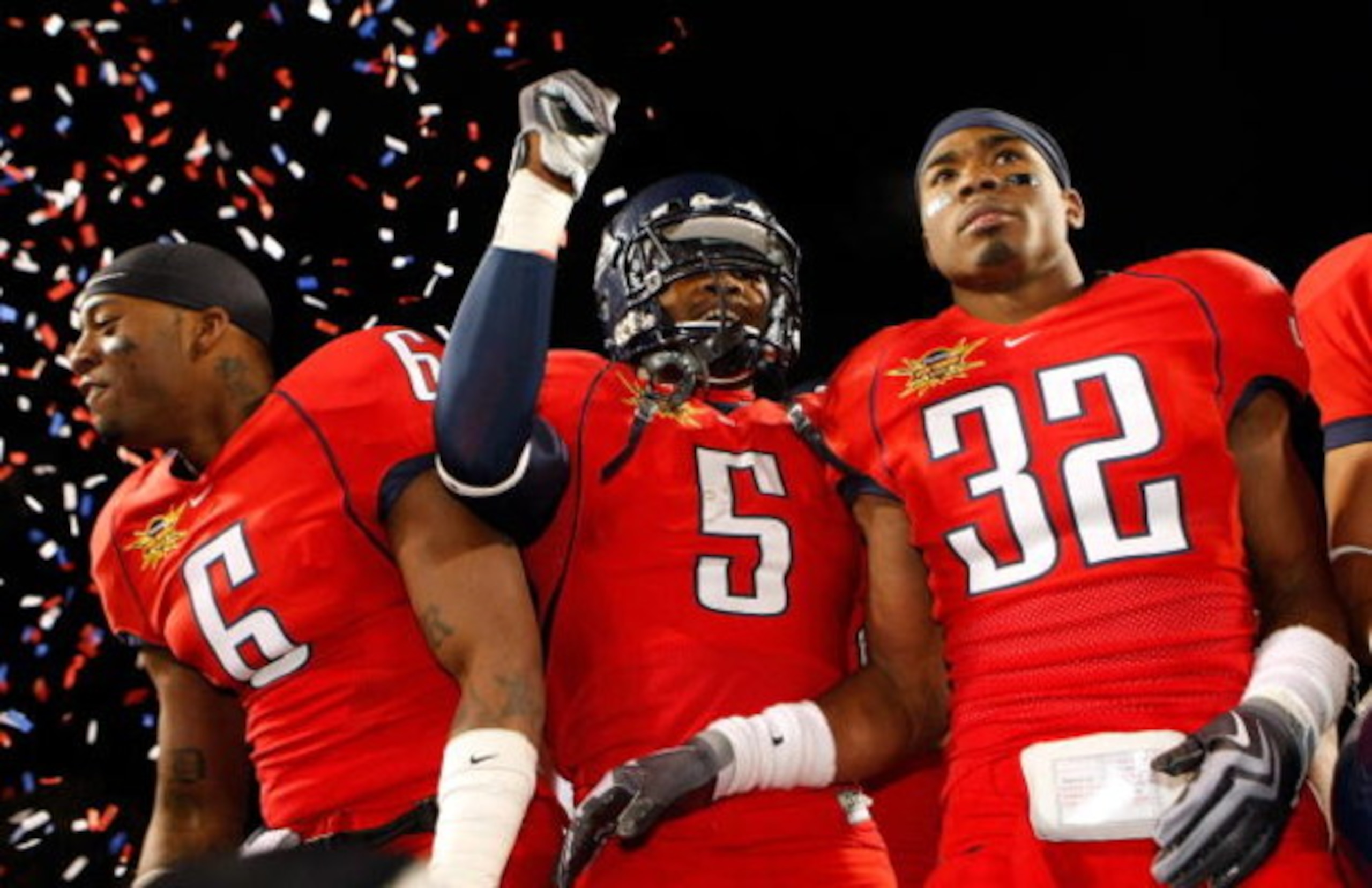 LAS VEGAS - DECEMBER 20:  Devon Ross #6, Nic Grigsby #5 and Nate Ness #32 of the Arizona Wildcats celebrate after the team's 31-21 victory over the Brigham Young University Cougars in the Pioneer Las Vegas Bowl at Sam Boyd Stadium December 20, 2008 in Las