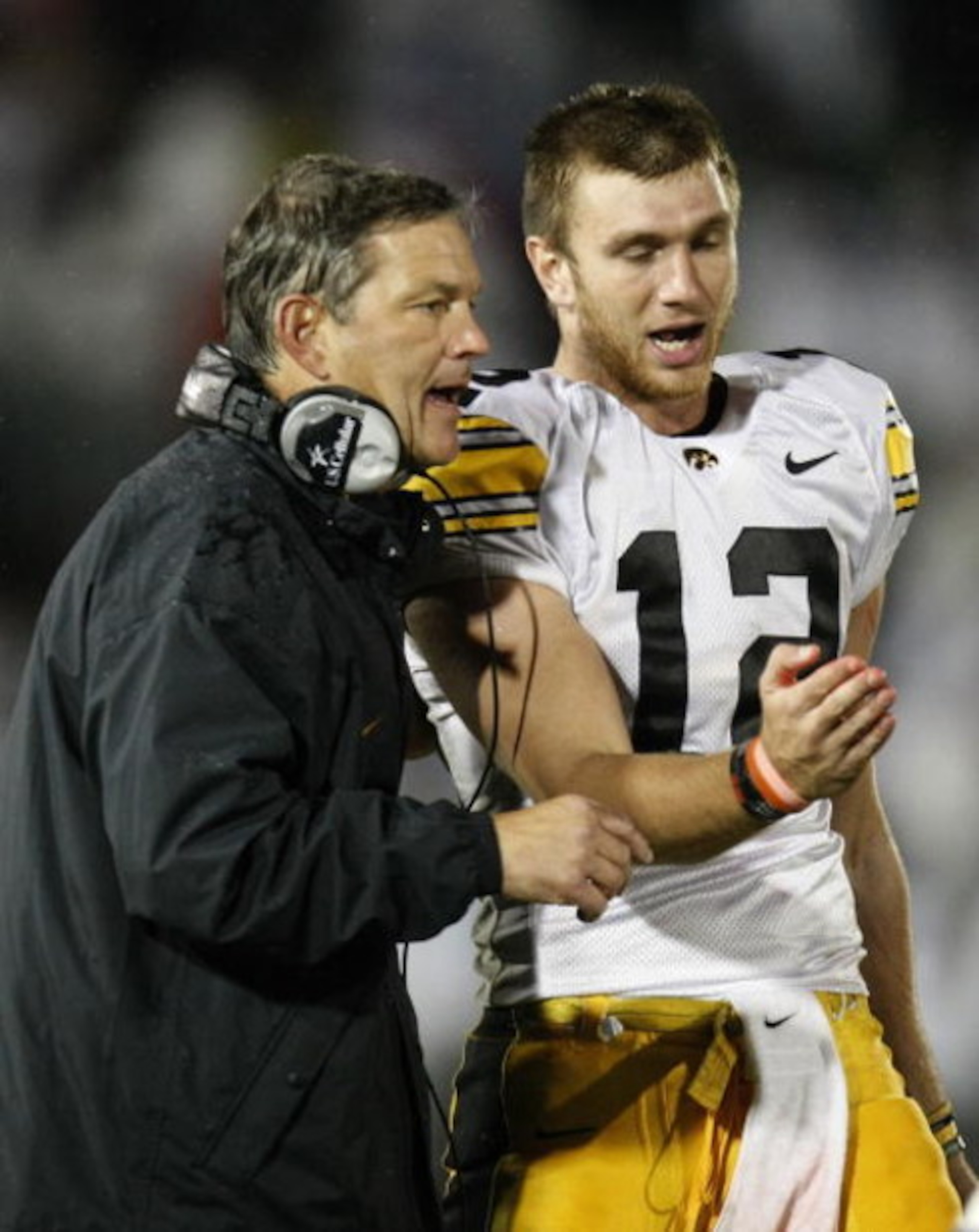 STATE COLLEGE, PA - SEPTEMBER 26:  Head coach Kirk Ferentz of the Iowa Hawkeyes talks with Ricky Stanzi #12 while playing the Penn State Nittnay Lions  on September 26, 2009 at Beaver Stadium in State College, Pennsylvania. Iowa won the game 21-10. (Photo