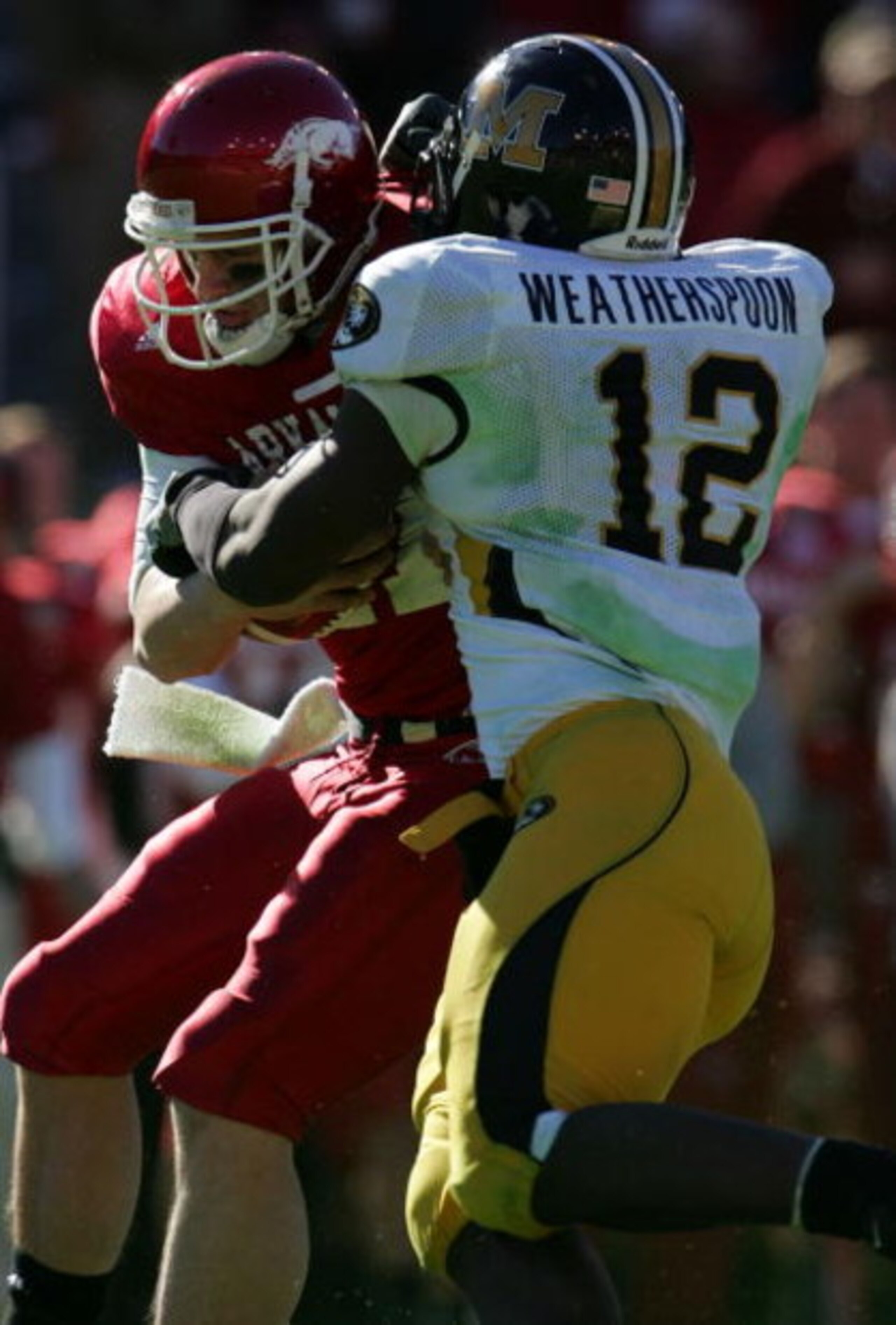 DALLAS - JANUARY 01:  Quarterback Casey Dick #11 of the Arkansas Razorbacks is sacked by Sean Weatherspoon #12 of the Missouri Tigers during the AT&T Cotton Bowl Classic on January 1, 2008 at the Cotton Bowl in Dallas, Texas.  (Photo by Ronald Martinez/Ge