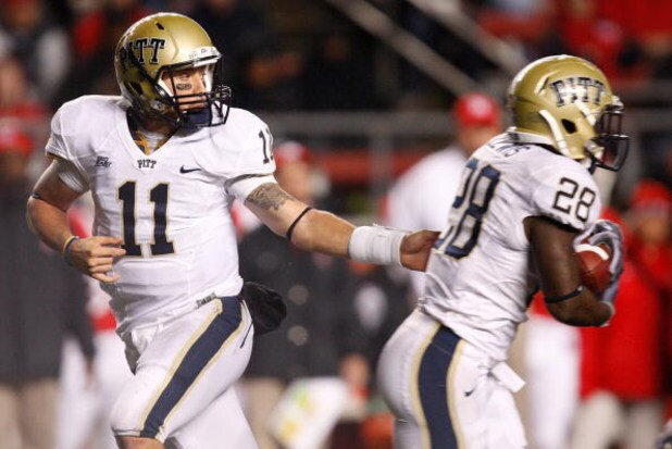 PISCATAWAY, NJ - OCTOBER 16: Bill Stull #11 hands the ball off to Dion Lewis #28 of the University of Pittsburgh Panthers against the Rutgers University Scarlett Knights on October 16, 2009 at Rutgers Stadium in Piscataway, New Jersey.  (Photo by Jared Wi