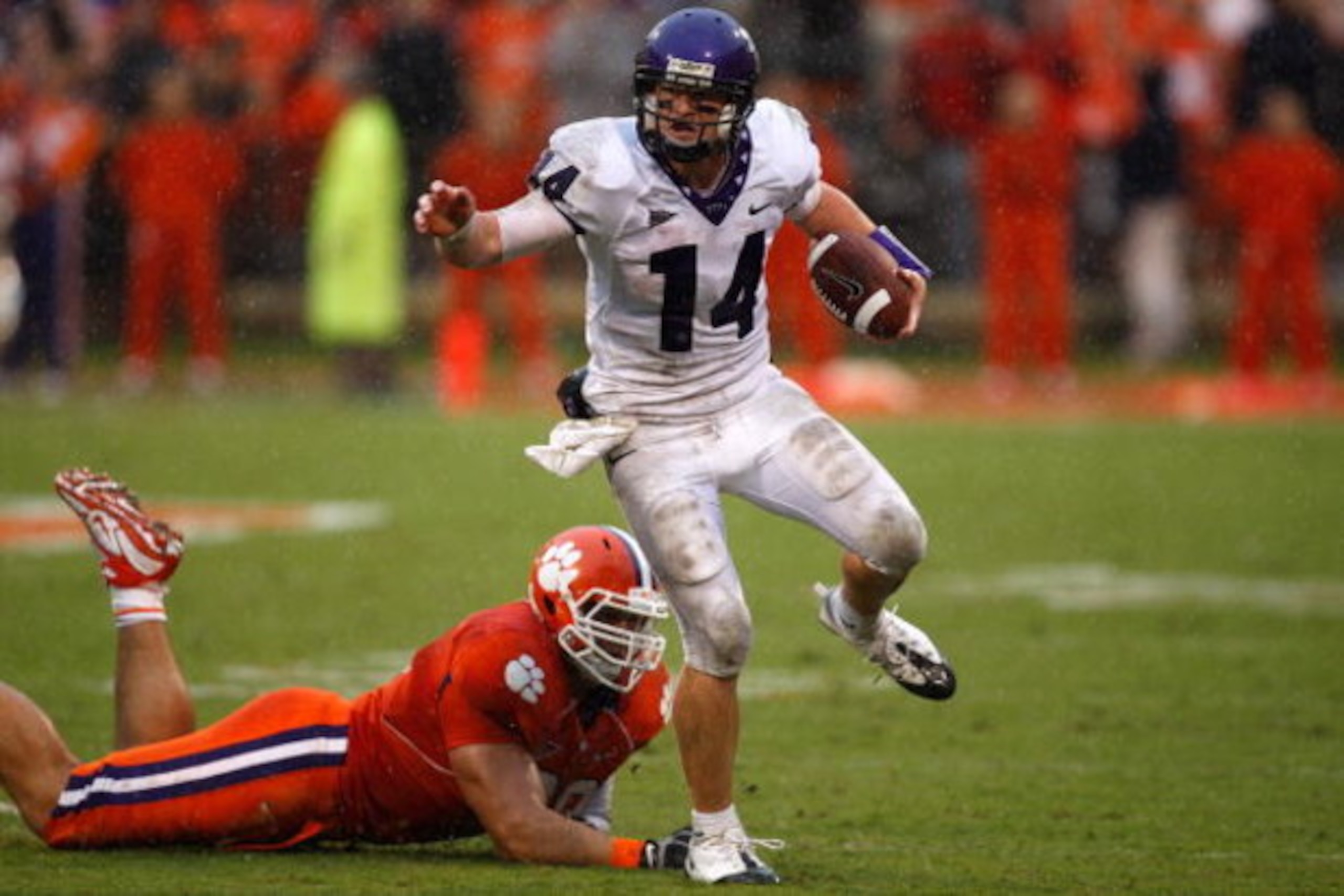 CLEMSON, SC - SEPTEMBER 26: Andy Dalton #14 of the TCU Horned Frogs runs with the ball as Miguel Chavis #89 of the Clemson Tigers tries to tackle him during their game at Memorial Stadium on September 26, 2009 in Clemson, South Carolina. (Photo by Stree CLEMSON, SC - SEPTEMBER 26: Andy Dalton #14 of the TCU Horned Frogs runs with the ball as Miguel Chavis #89 of the Clemson Tigers tries to tackle him during their game at Memorial Stadium on September 26, 2009 in Clemson, South Carolina. (Photo by Stree