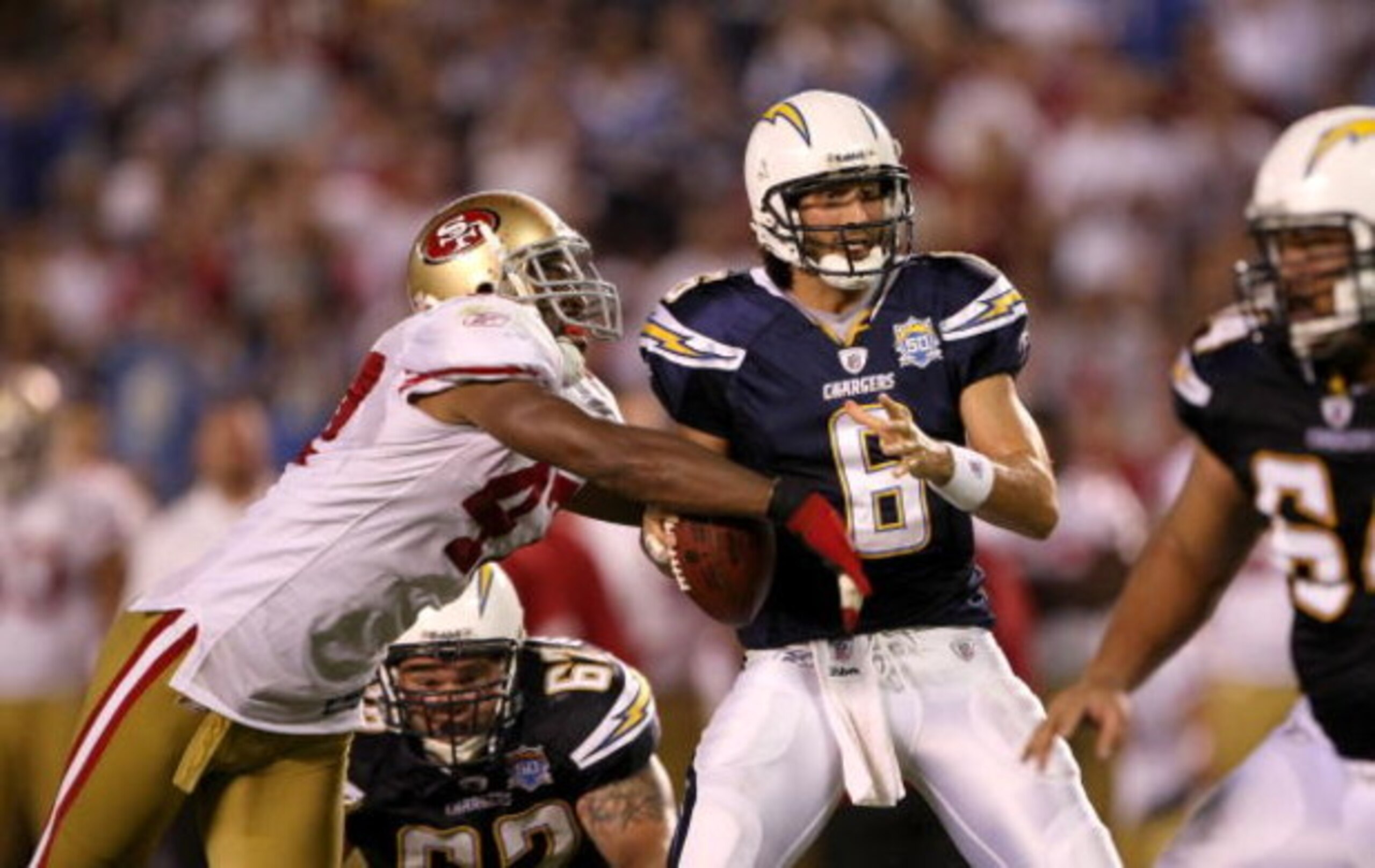 SAN DIEGO - SEPTEMBER 4: Linebacker Diyral Briggs #47 of the San Francisco 49ers knocks the ball out of the hand of quarterback Charlie Whithurst #6 of the San Diego Chargers and force a turnover on the 12 yard line on September 4, 2009 at Qualcomm Stadiu
