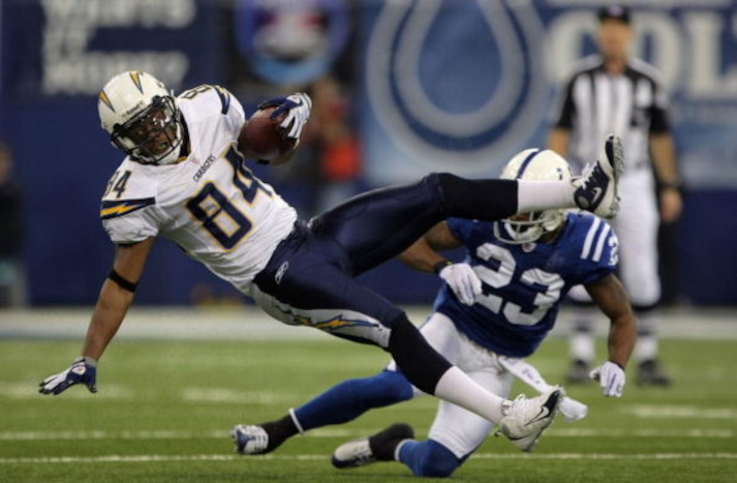 INDIANAPOLIS - JANUARY 13:  Buster Davis #84 of the San Diego Chargers makes a reception for a first down against Tim Jennings #23 of the Indianapolis Colts against the San Diego Chargers during their AFC Divisional Playoff game at the RCA Dome on January
