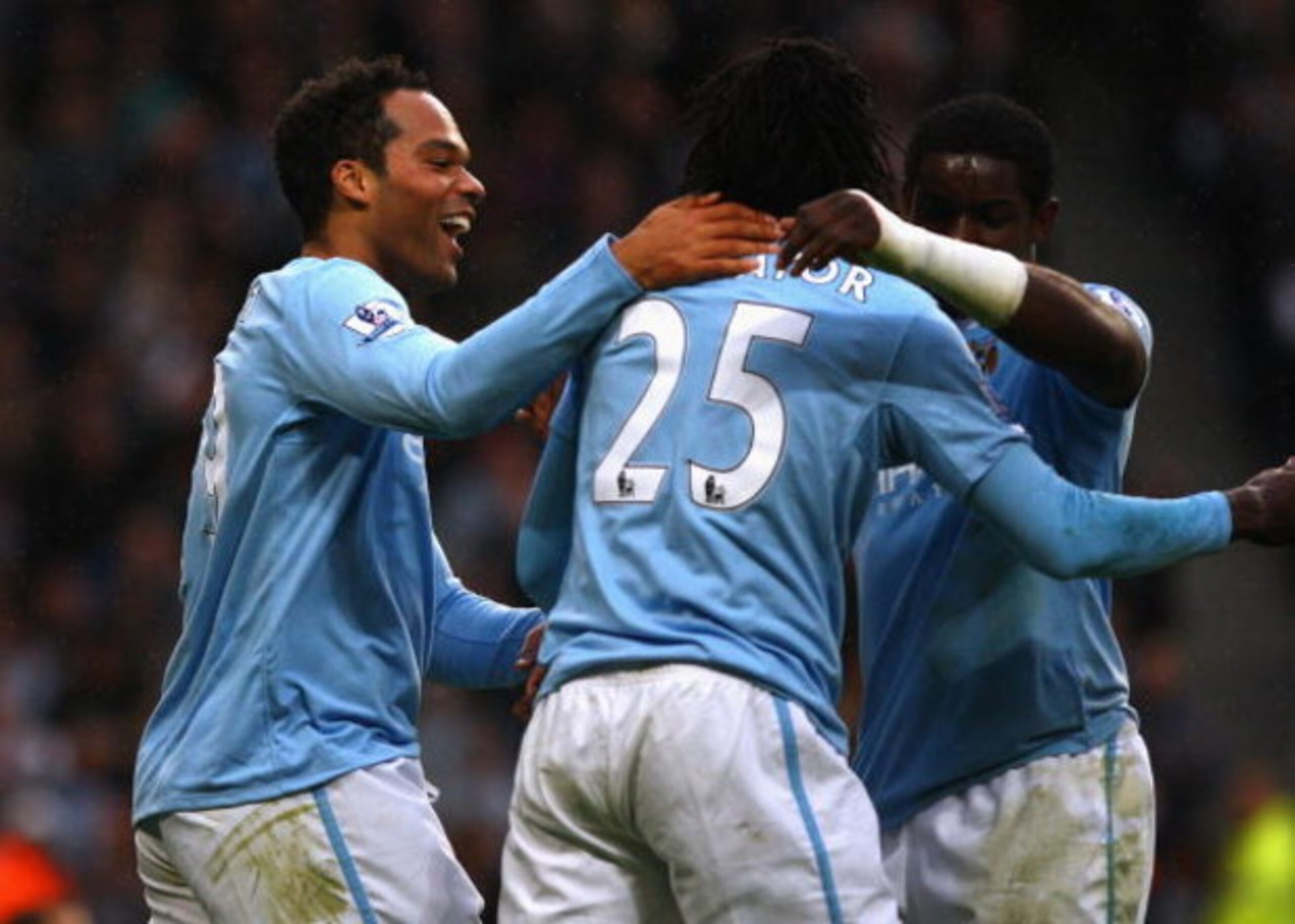 MANCHESTER, ENGLAND - OCTOBER 25:  Joleon Lescott of Manchester City celebrates with Emmanuel Adebayor after scoring the opening goal during the Barclays Premier League match between Manchester City and Fulham at the City of Manchester Stadium on October 