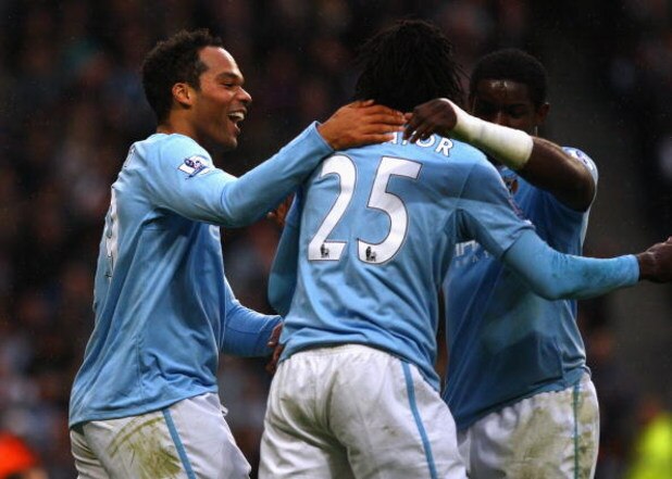 MANCHESTER, ENGLAND - OCTOBER 25:  Joleon Lescott of Manchester City celebrates with Emmanuel Adebayor after scoring the opening goal during the Barclays Premier League match between Manchester City and Fulham at the City of Manchester Stadium on October 