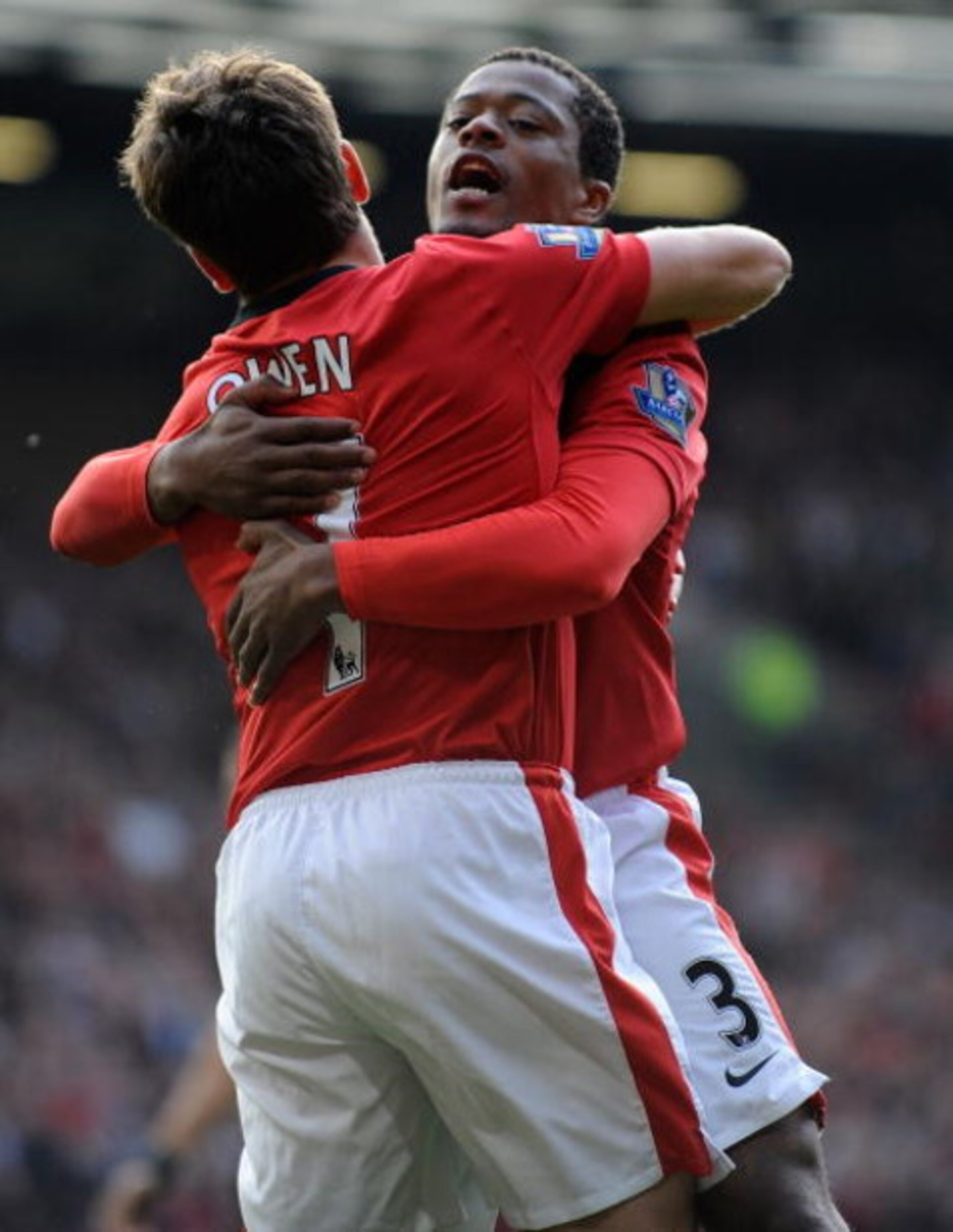 MANCHESTER, ENGLAND - OCTOBER 17: Michael Owen and Patrice Evra of Manchester United celebrate the first goal during the Barclays Premier League match between Manchester United and Bolton Wanderers at Old Trafford on October 17, 2009 in Manchester, Englan