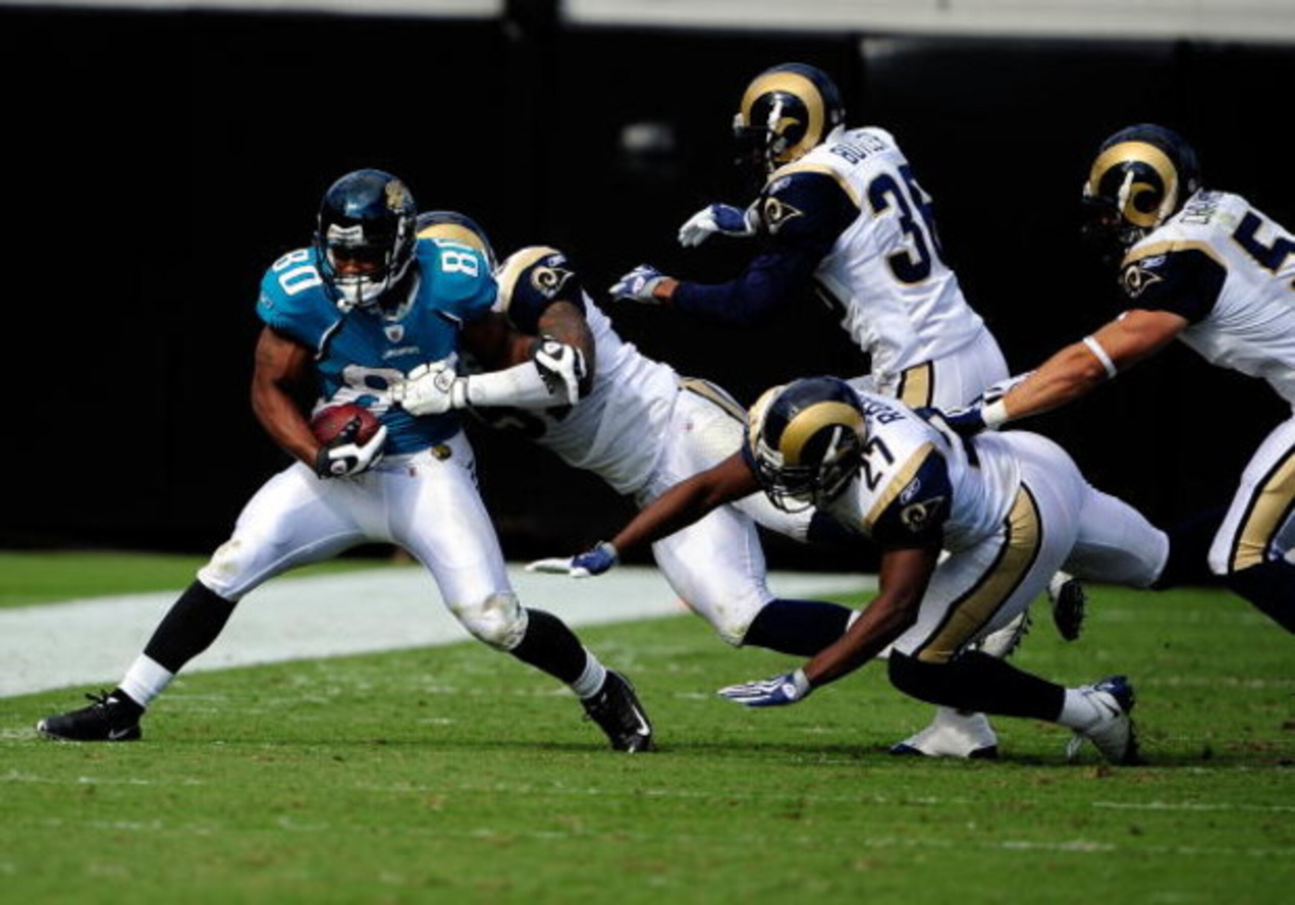JACKSONVILLE, FL - OCTOBER 18:  Mike Thomas #80 of the Jacksonville Jaguars is tackled by Quincy Butler #36 of the St. Louis Rams during the game at Jacksonville Municipal Stadium on October 18, 2009 in Jacksonville, Florida.  (Photo by Sam Greenwood/Gett