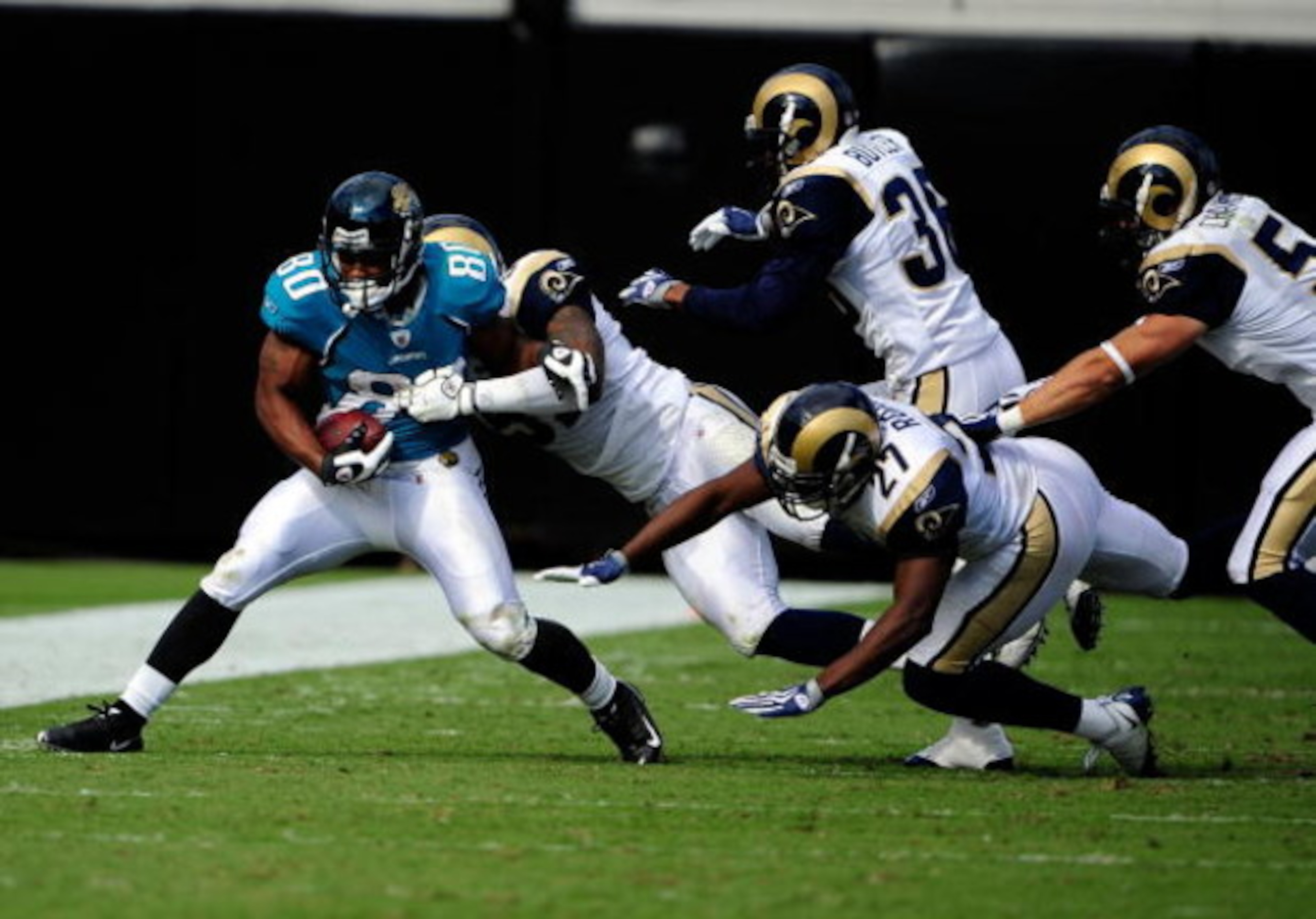 JACKSONVILLE, FL - OCTOBER 18:  Mike Thomas #80 of the Jacksonville Jaguars is tackled by Quincy Butler #36 of the St. Louis Rams during the game at Jacksonville Municipal Stadium on October 18, 2009 in Jacksonville, Florida.  (Photo by Sam Greenwood/Gett