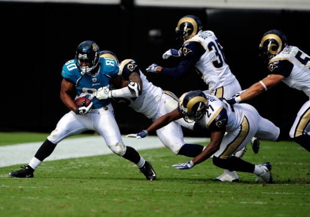 JACKSONVILLE, FL - OCTOBER 18:  Mike Thomas #80 of the Jacksonville Jaguars is tackled by Quincy Butler #36 of the St. Louis Rams during the game at Jacksonville Municipal Stadium on October 18, 2009 in Jacksonville, Florida.  (Photo by Sam Greenwood/Gett