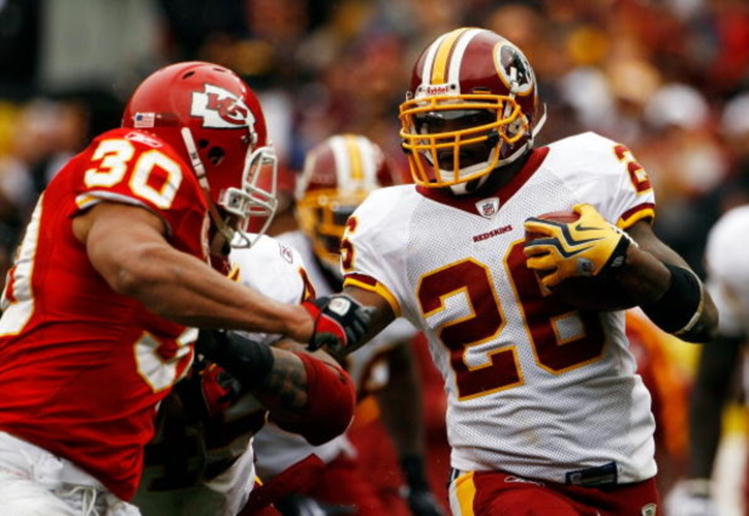 LANDOVER, MD - OCTOBER 18:  Mike Brown #30 of the Kansas City Chiefs tackles Clinton Portis #26 of the Washington Redskins during their game October 18, 2009 at FedEx Field in Landover, Maryland.The Chiefs won the game 14-6.  (Photo by Win McNamee/Getty I