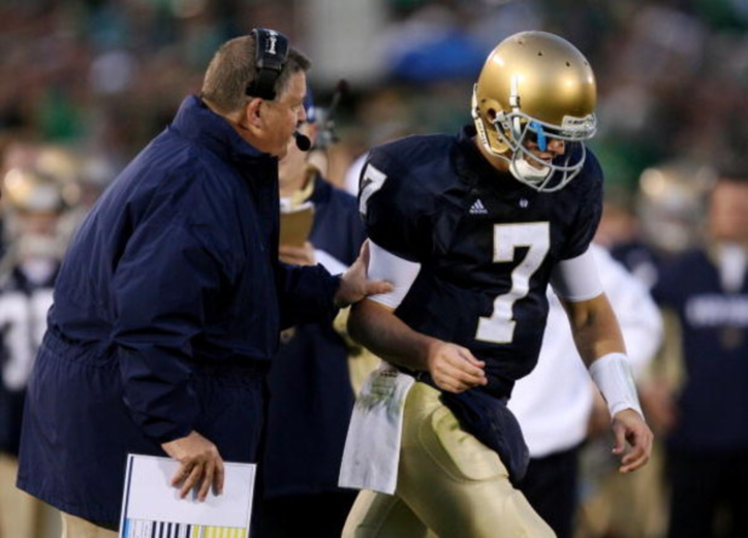 SOUTH BEND, IN - OCTOBER 17: Head coach Charlie Weis of the Notre Dame Fighting Irish speaks to quarterback Jimmy Clausen #7 during the fourth quarter against the USC Trojans at Notre Dame Stadium on October 17, 2009 in South Bend, Indiana. USC won the ga