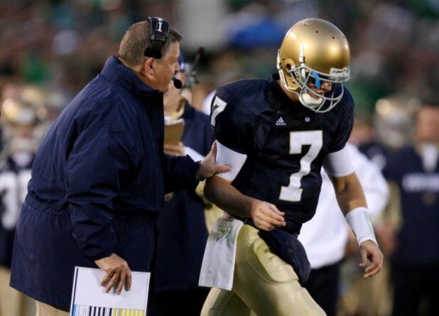 SOUTH BEND, IN - OCTOBER 17: Head coach Charlie Weis of the Notre Dame Fighting Irish speaks to quarterback Jimmy Clausen #7 during the fourth quarter against the USC Trojans at Notre Dame Stadium on October 17, 2009 in South Bend, Indiana. USC won the ga