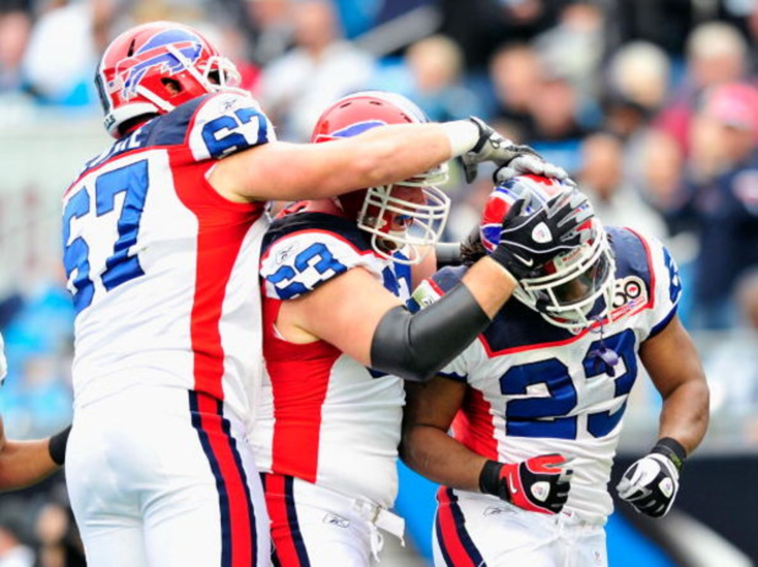 CHARLOTTE, NC - OCTOBER 25:  Andy Levitre #67, Geoff Hangartner #63 and Marshawn Lynch #23 of the Buffalo Bills during celebrate Lynch's touchdown against the Carolina Panthers at Bank of America Stadium on October 25, 2009 in Charlotte, North Carolina.  
