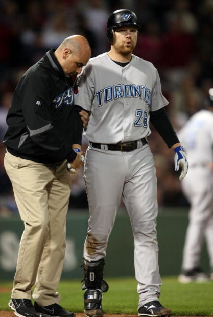 BOSTON - SEPTEMBER 29:  Adam Lind #26 of the Toronto Blue Jays is looked after by a member of the medical staff after he was hit by a pitch in the ninth inning against the Boston Red Sox on September 29, 2009 at Fenway Park in Boston, Massachusetts. The B