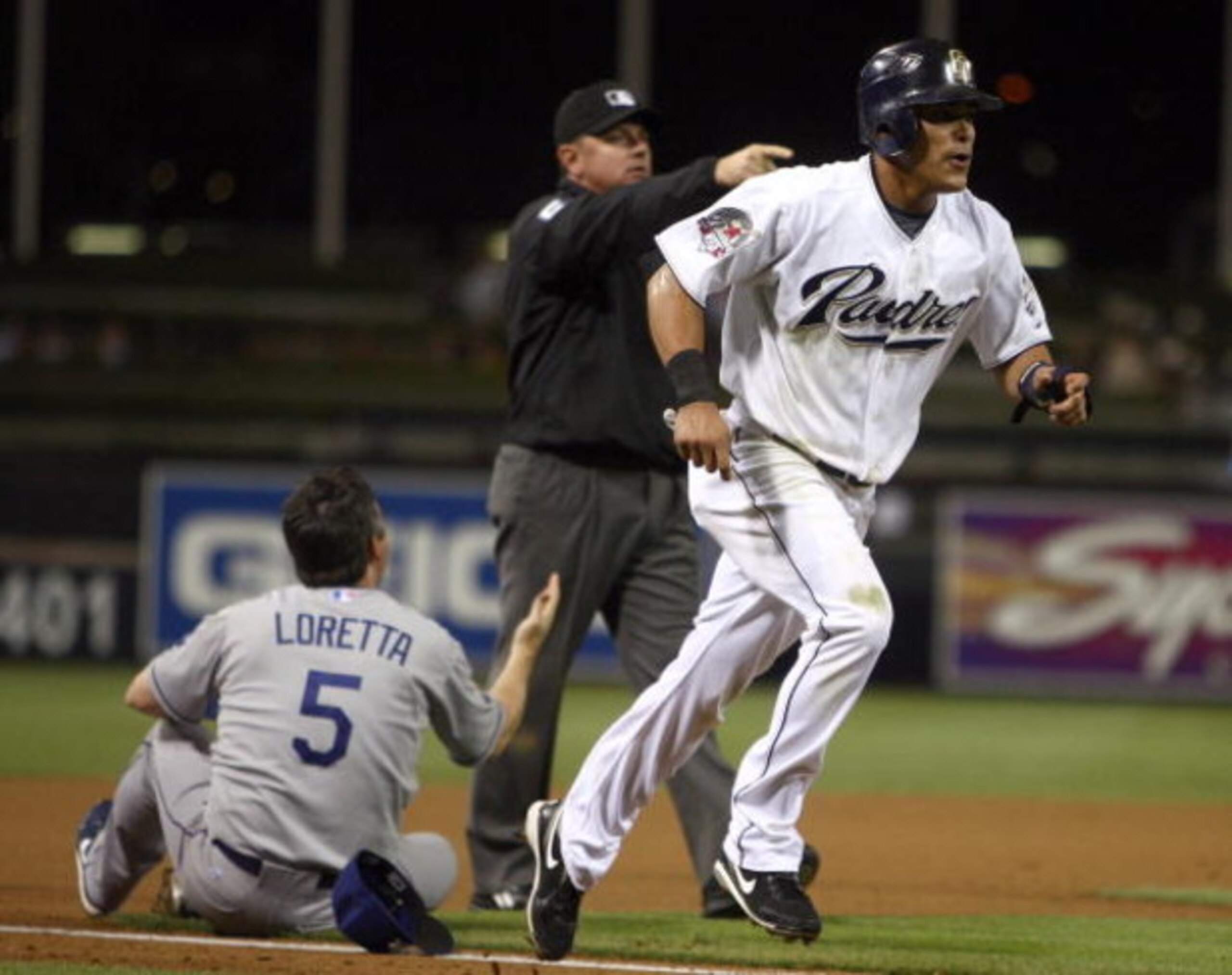 SAN DIEGO, CA - SEPTEMBER 30:  Everth Cabrera #1 of the San Diego Chargers is called to home by the umpire after third-baseman Mark Loretta #5 of the Los Angeles Dodgers impeded his movement with his legs during the MLB game between the Los Angeles Dodger